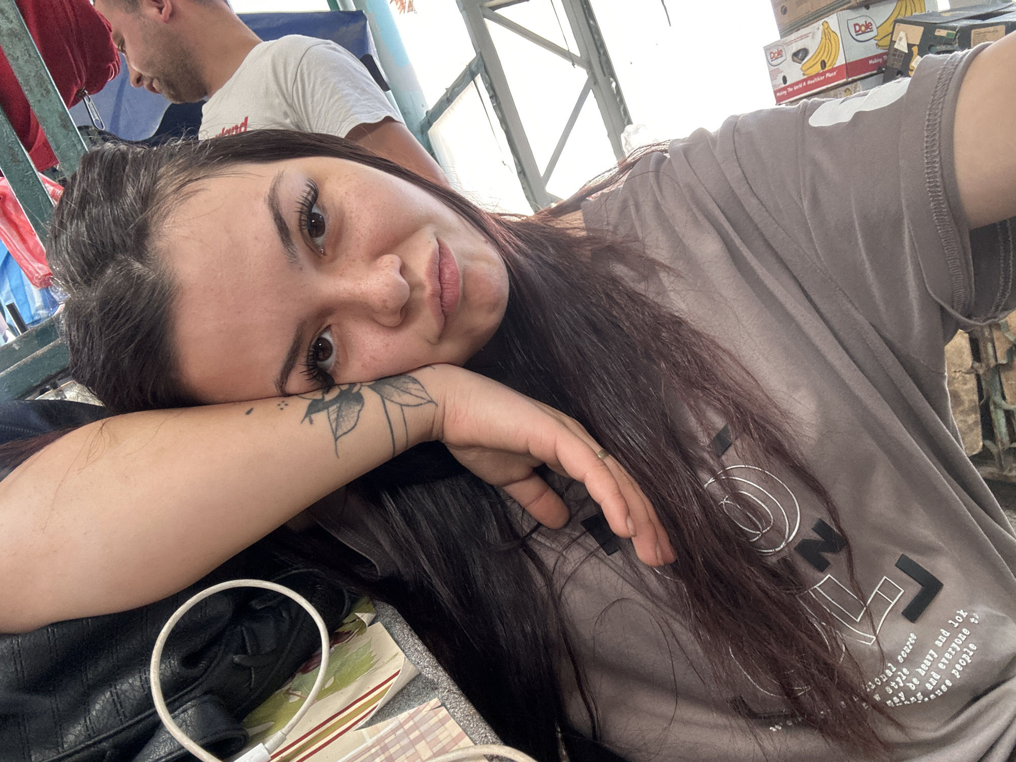 Woman takes selfies at outdoor market in Sliven, Bulgaria