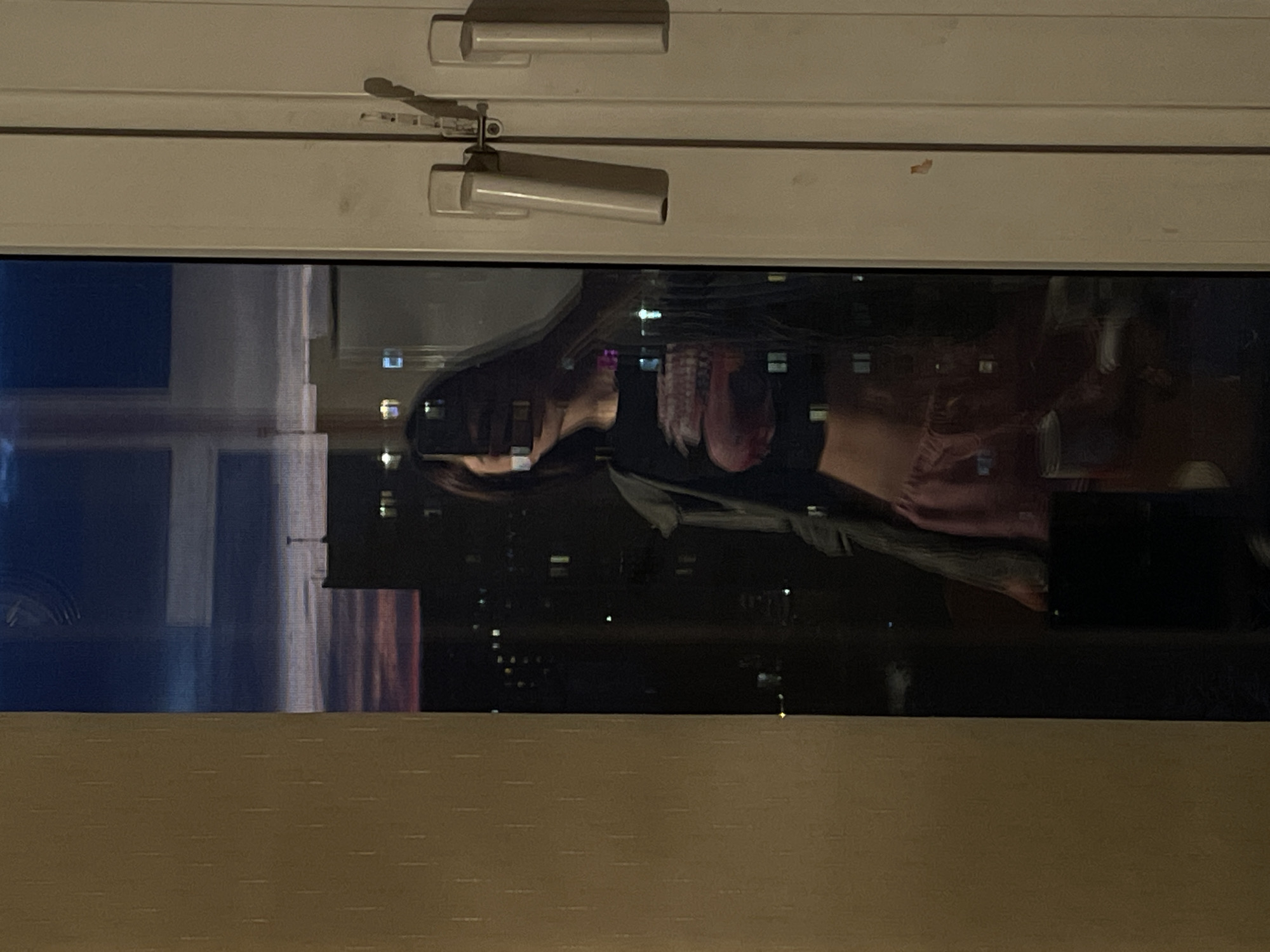 Person photographs window reflections in Moscow indoor setting