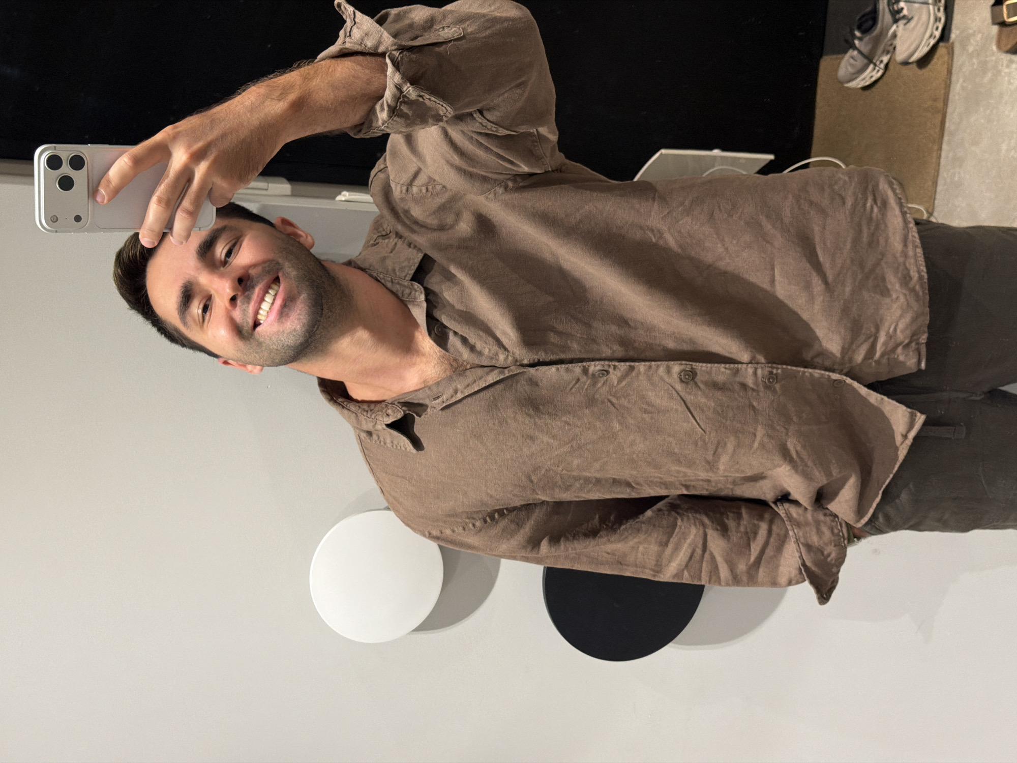Selfie against a minimalist grey wall with circular decor