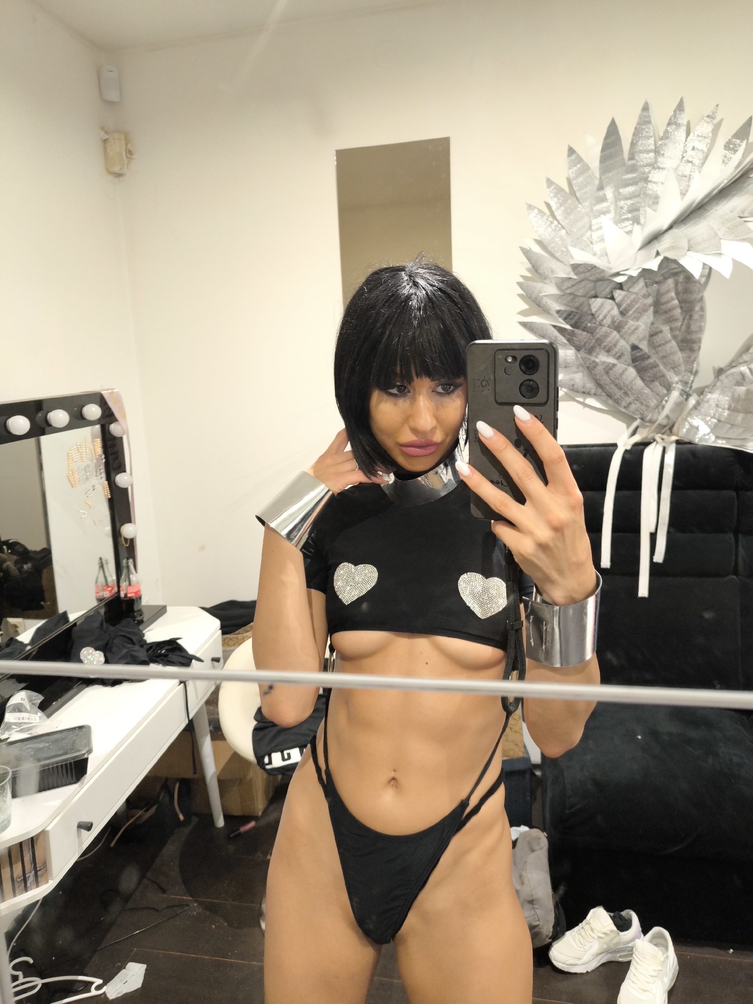 Woman Takes Selfie in Dressing Room Wearing Black and Silver