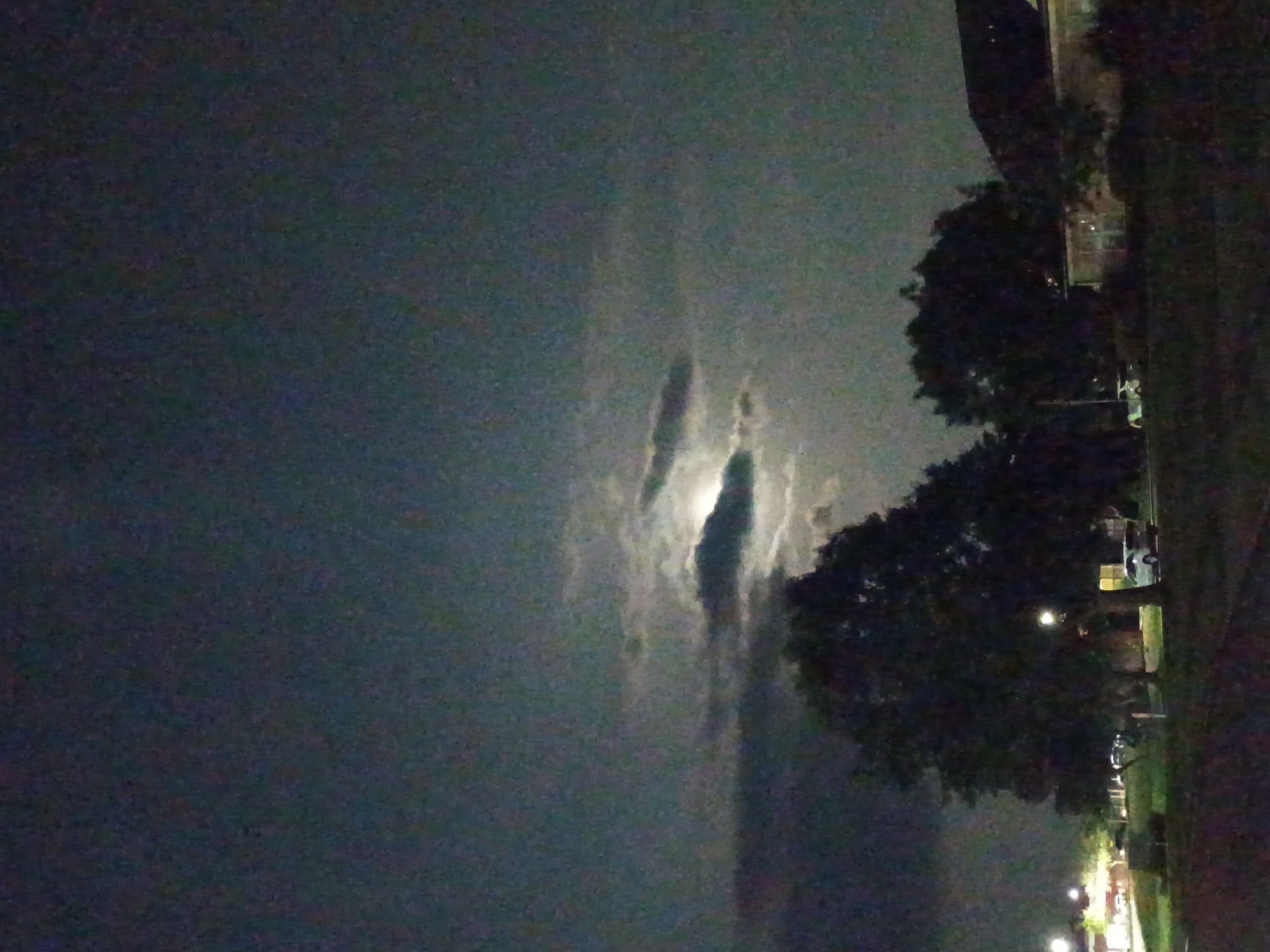 Moon and possible lightning share a cloudy Kentucky night sky