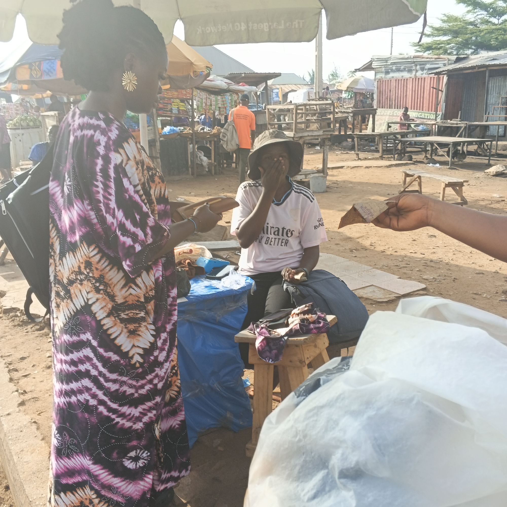 Morning street activity in Rido — markets, motos, and Keke Napeps