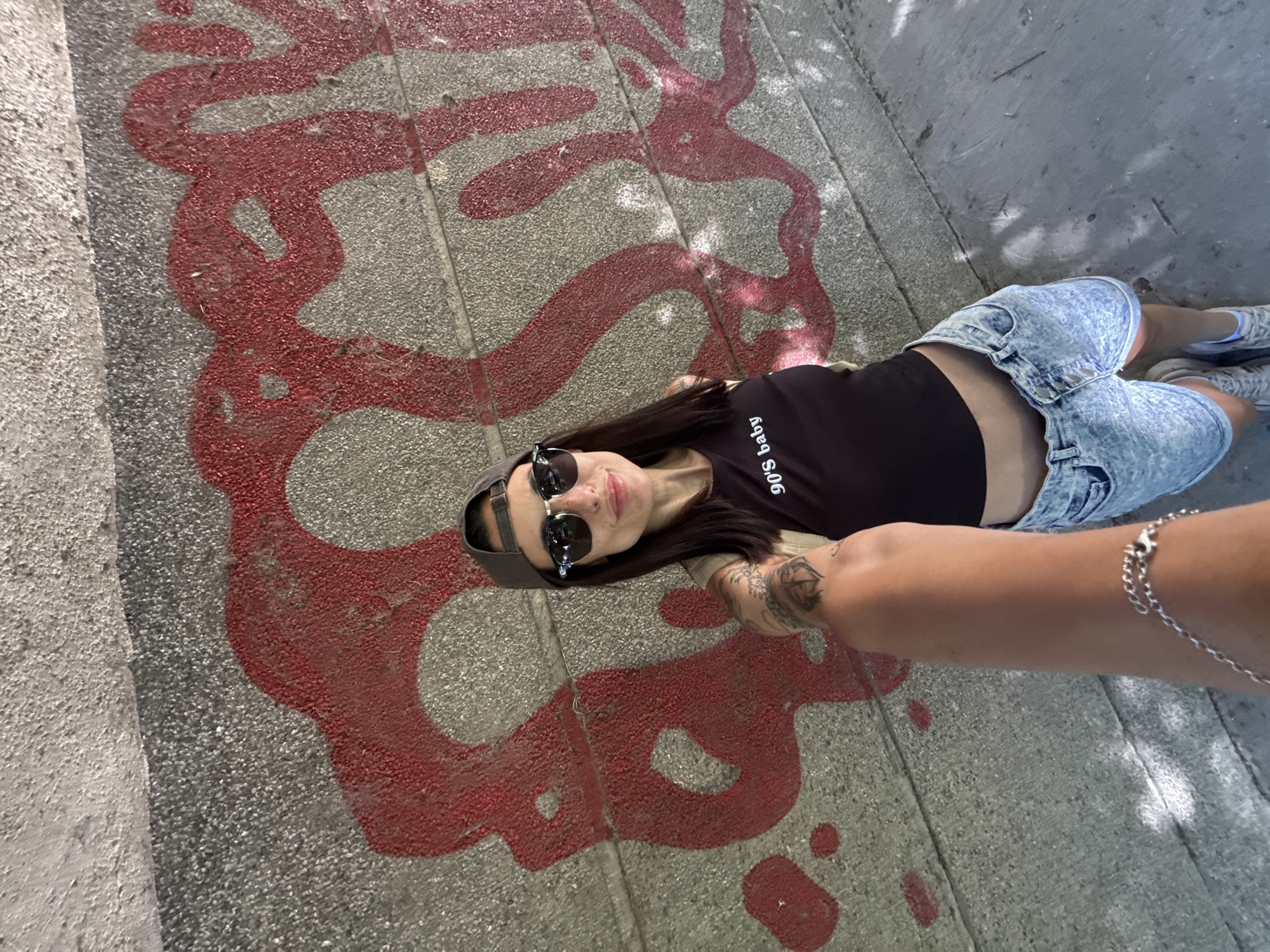 Woman in '90s baby' shirt photographed on Pleven street