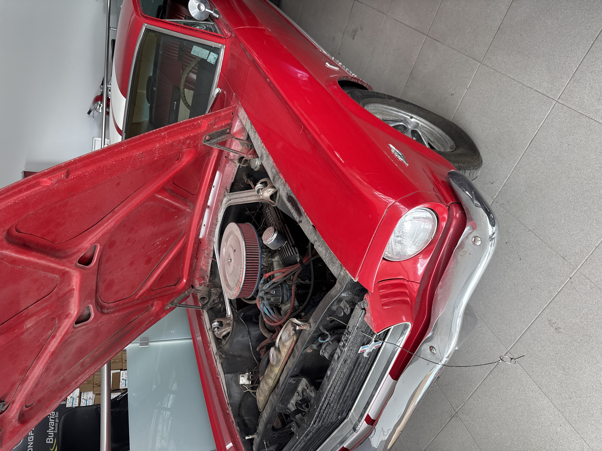 Vintage red car displayed with hood open in Varna museum