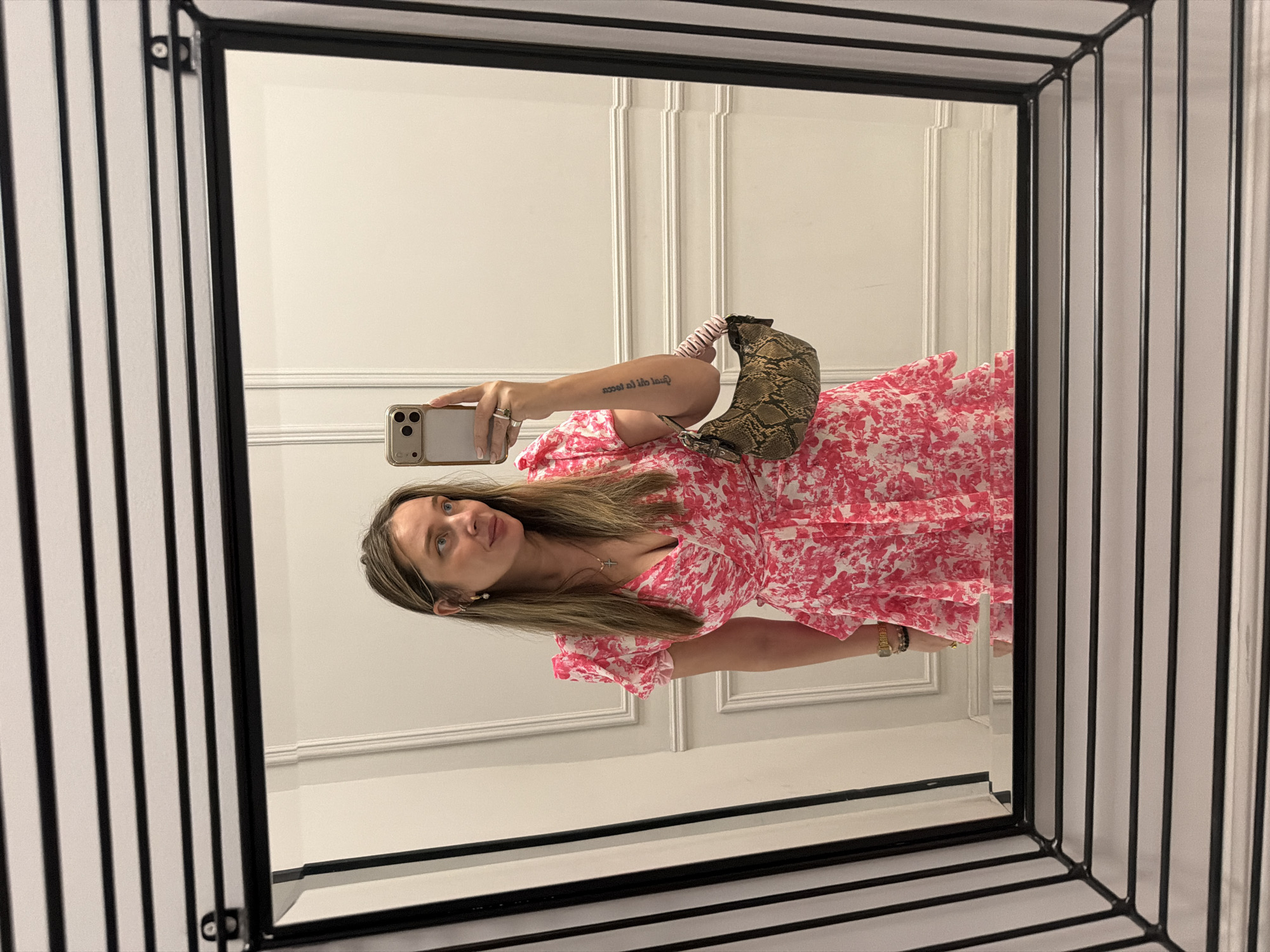 Woman takes selfie in mirror wearing floral dress, Moscow