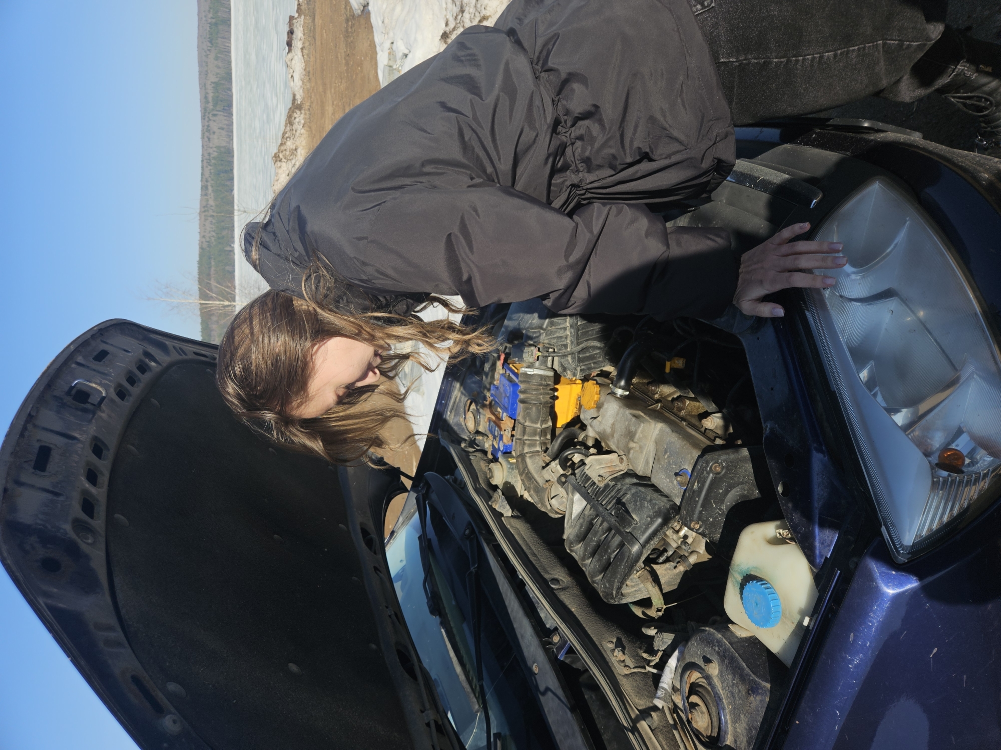 Woman documents daily routine with car repairs and selfies