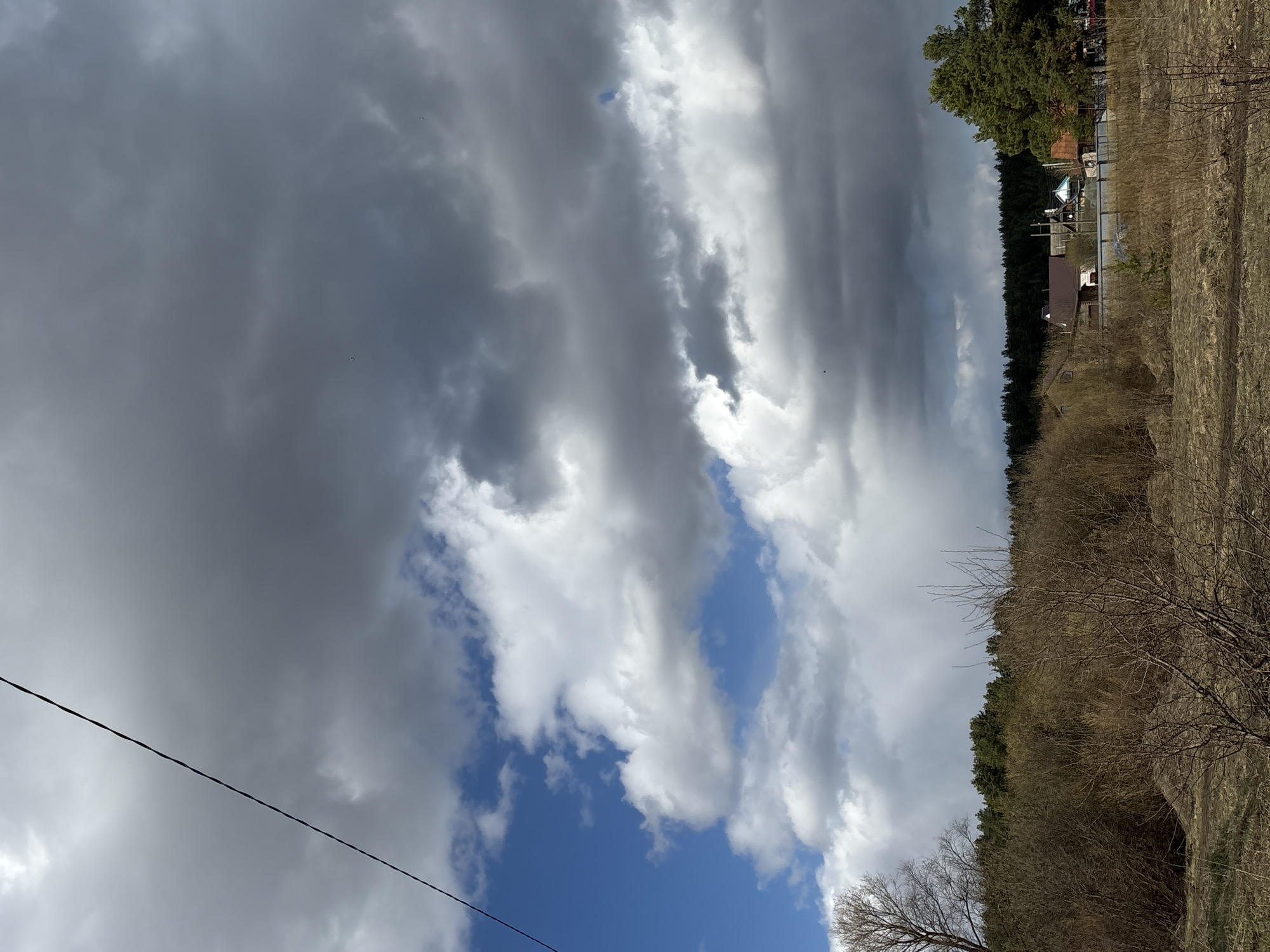 Rural Rusalevka landscape documented under dramatic spring skies