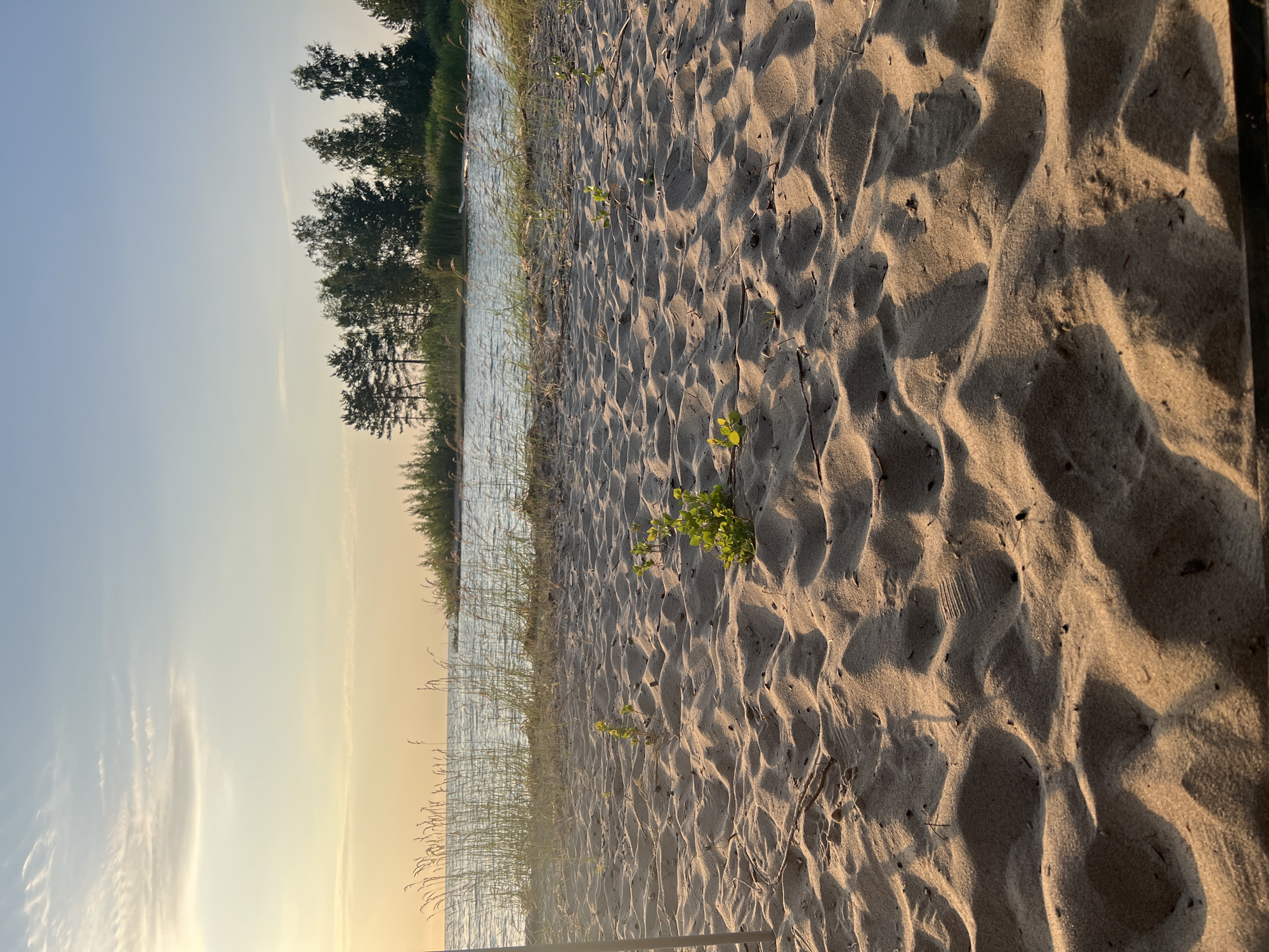 Sunset along a quiet Borovoe beach with an inflatable boat