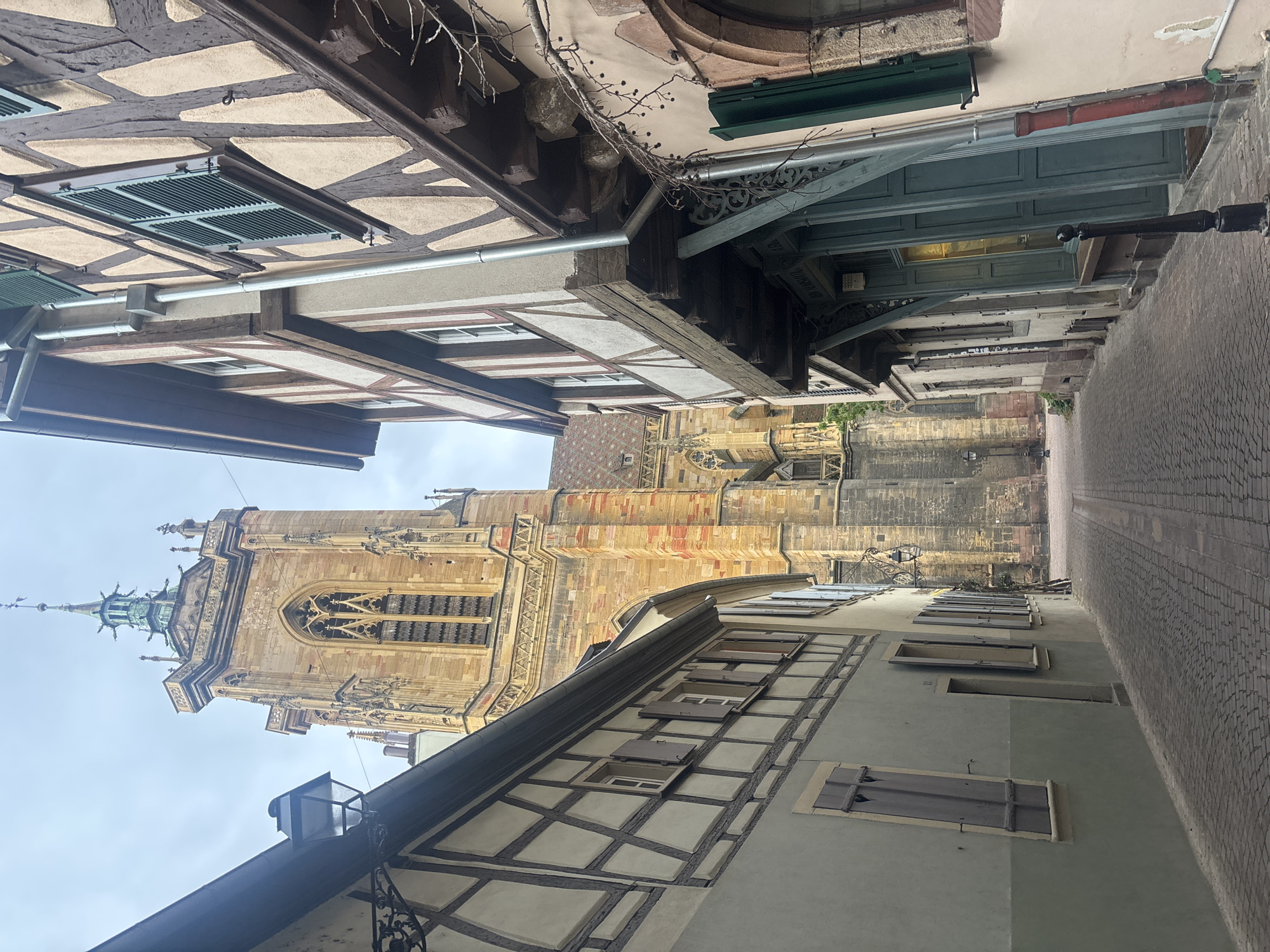 Tourist documents medieval architecture in Colmar's historic quarter