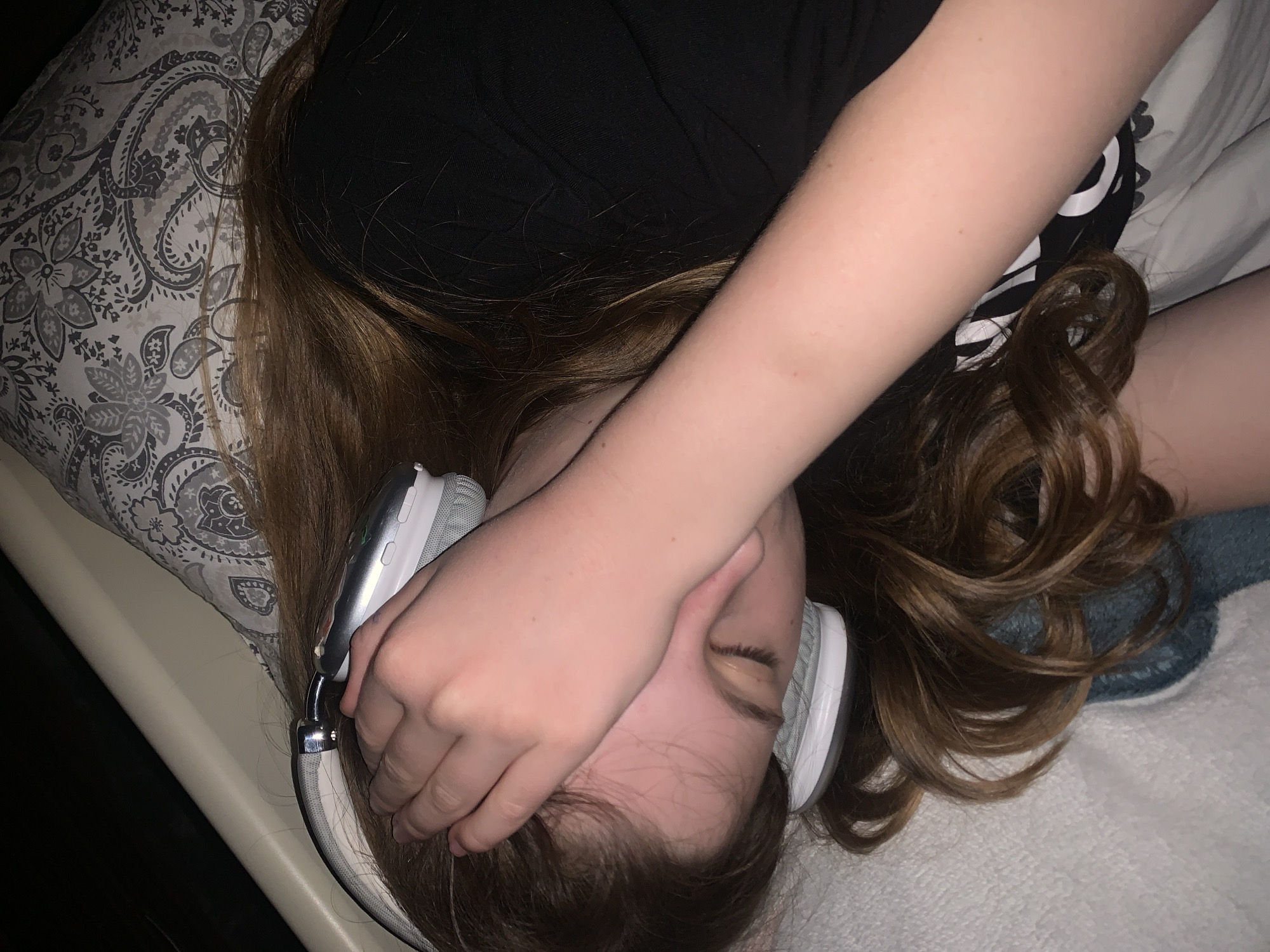 Person relaxes with headphones and yogurt in Belgrade bedroom