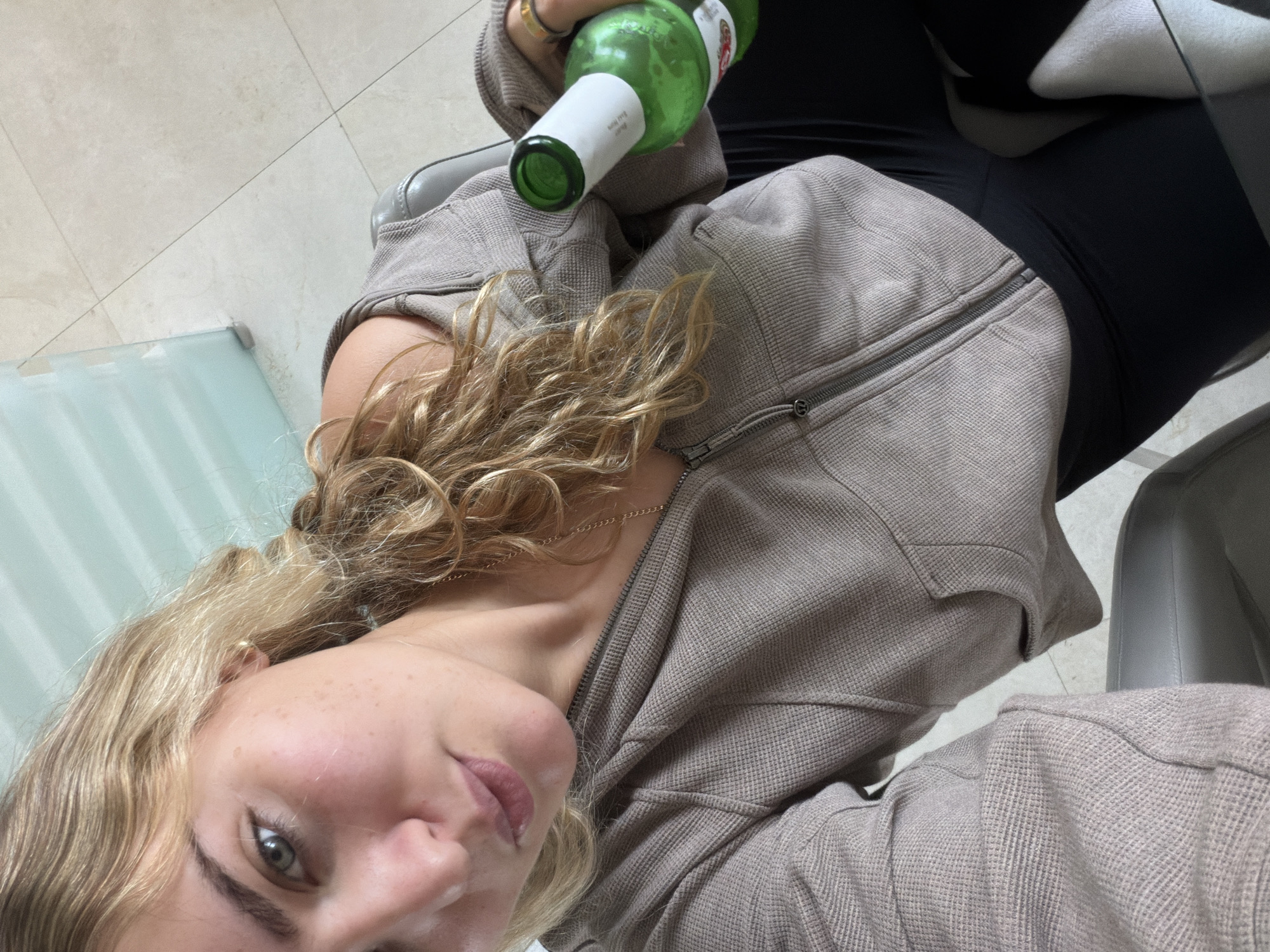 Woman with green bottle photographed indoors in Key Biscayne
