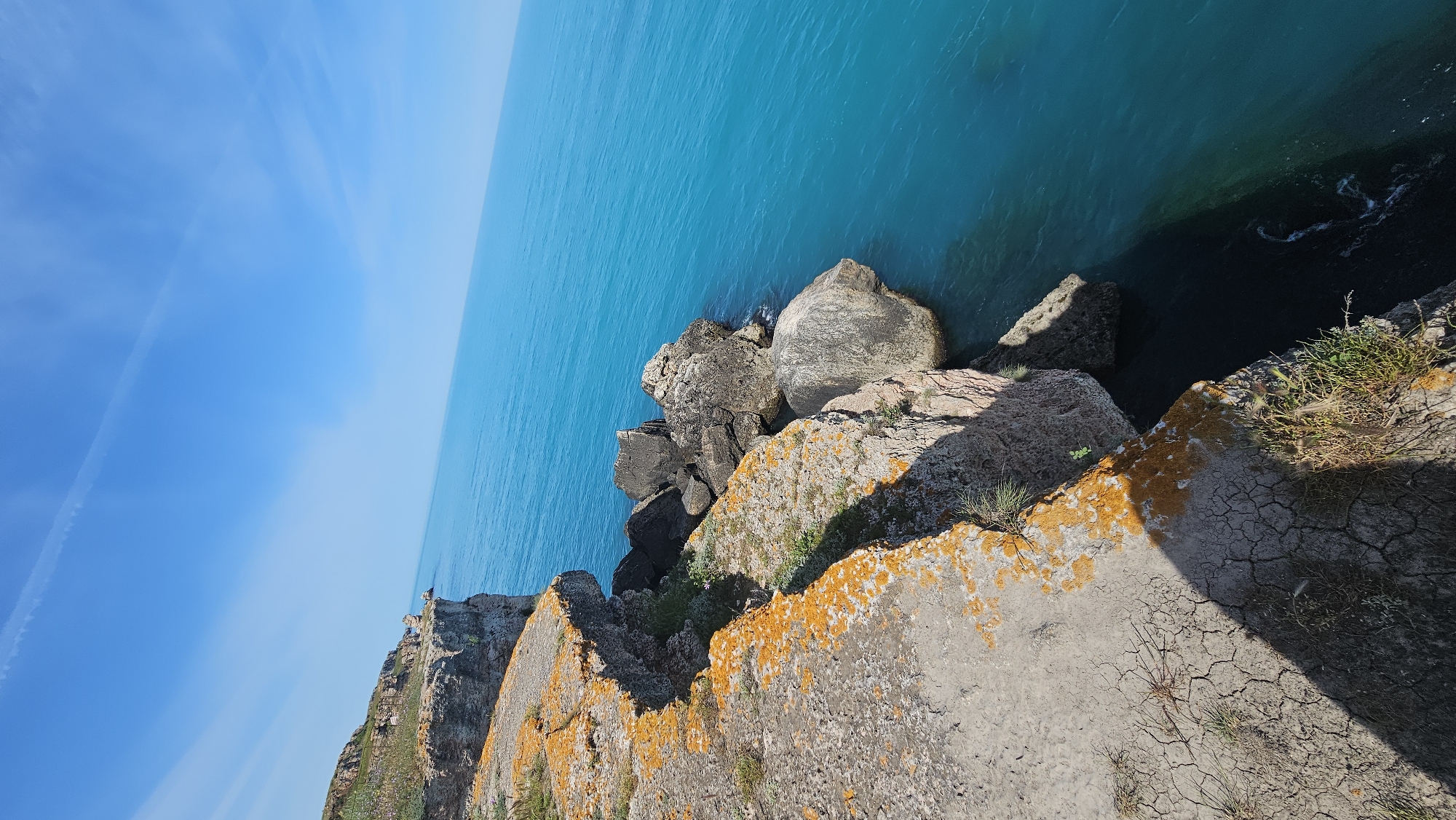 Tourists explore scenic Kamen Bryag cliffs overlooking Black Sea