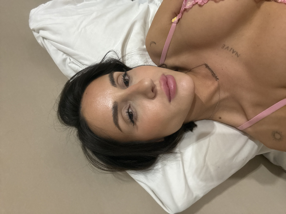 Woman with tattoos resting on pillow in Khimki