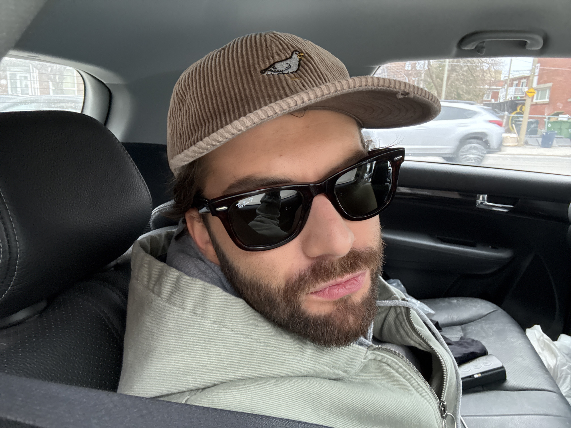 Two passengers drive past Montreal church using GPS navigation