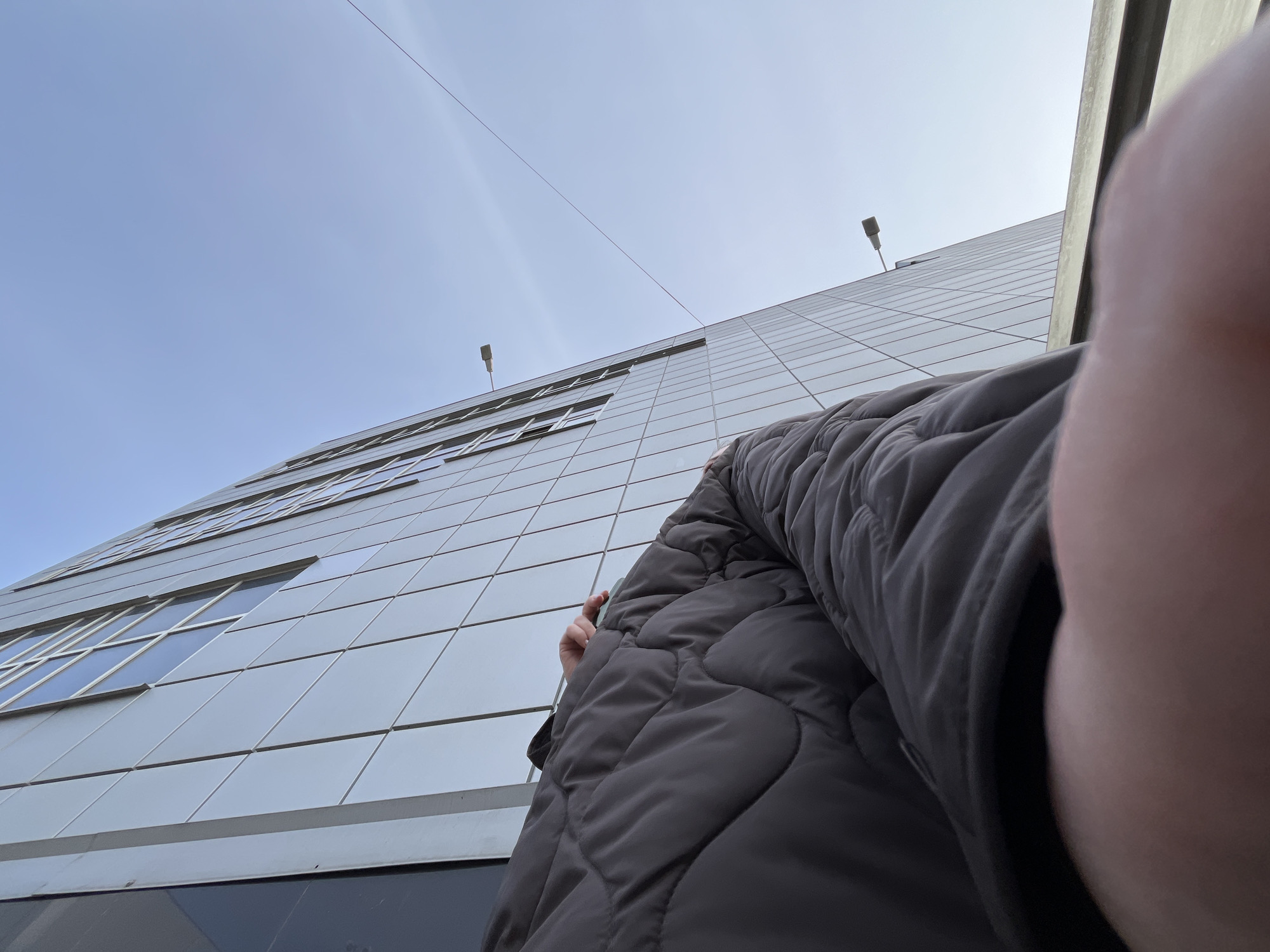 Woman photographed near modern building in Klin, Russia