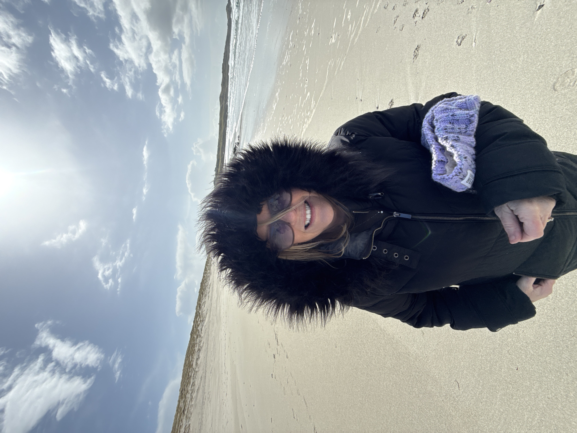 Beach visitors photographed during cloudy afternoon in April