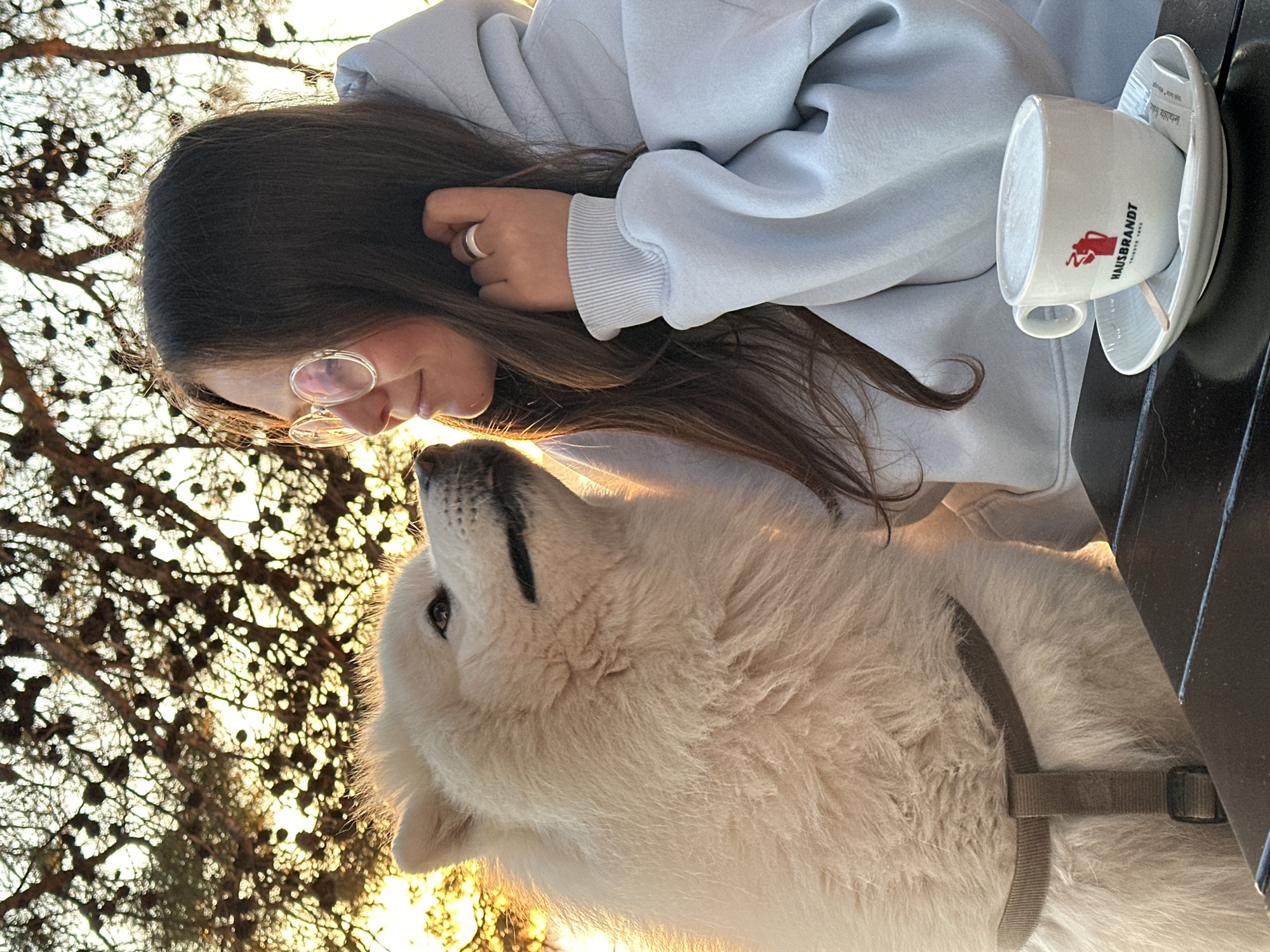 Woman and white dog enjoy golden hour sunset in Montenegro
