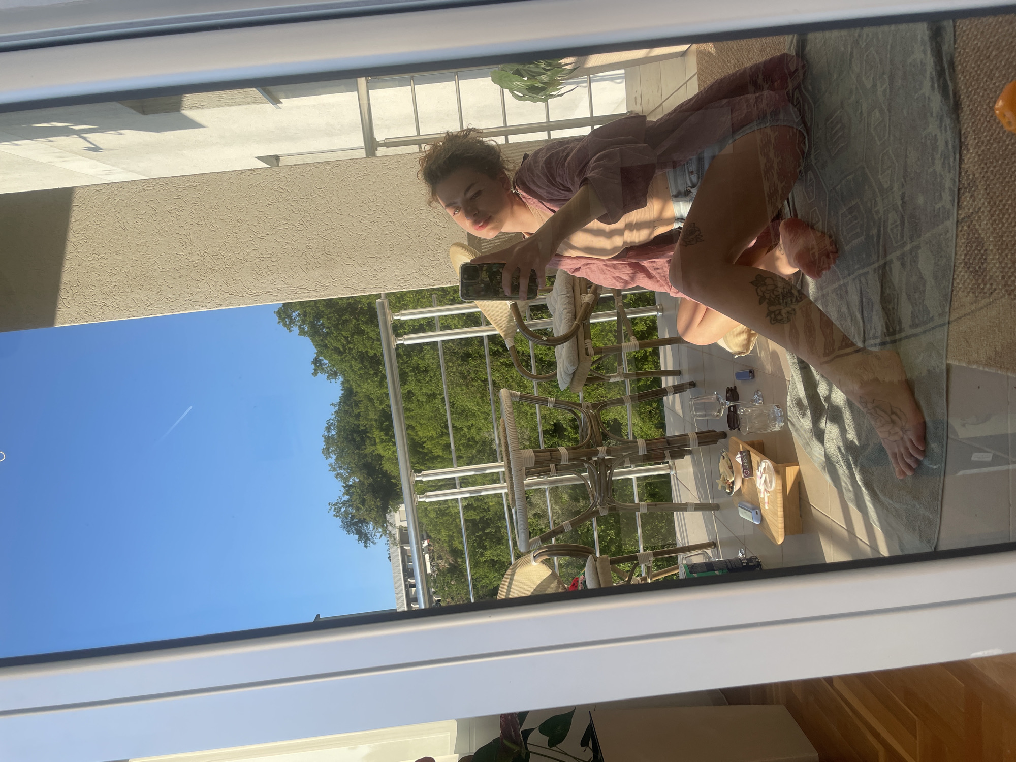 Woman takes selfie on balcony in Rafailovići, Montenegro