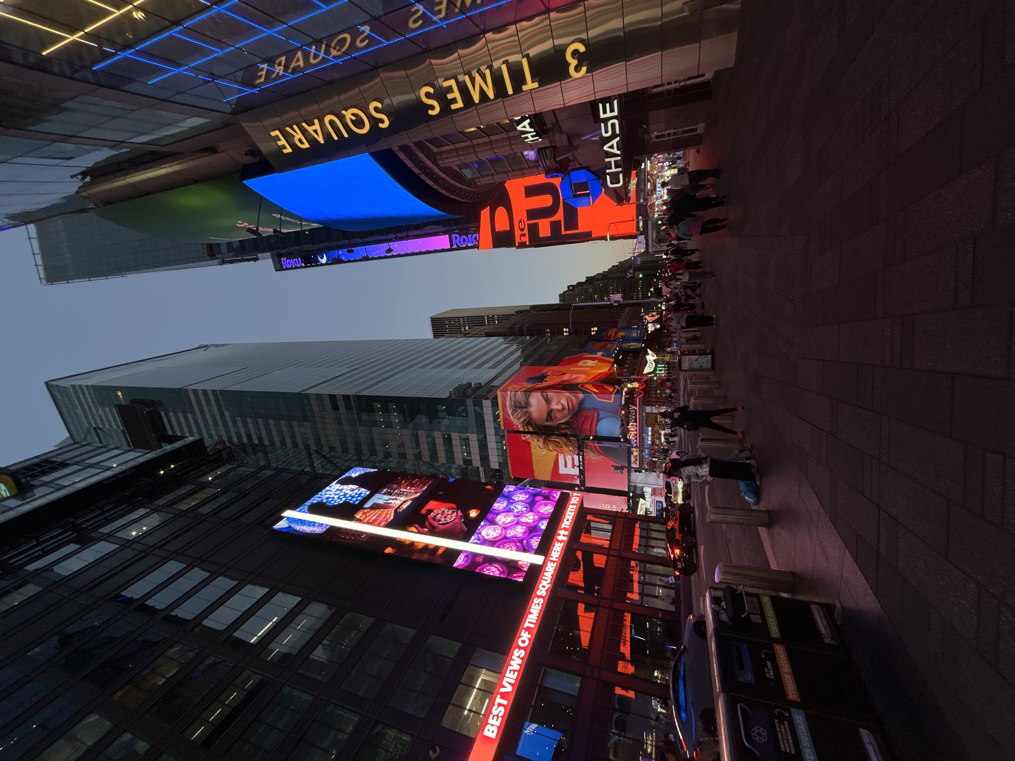 Late night crowds gather in illuminated Times Square