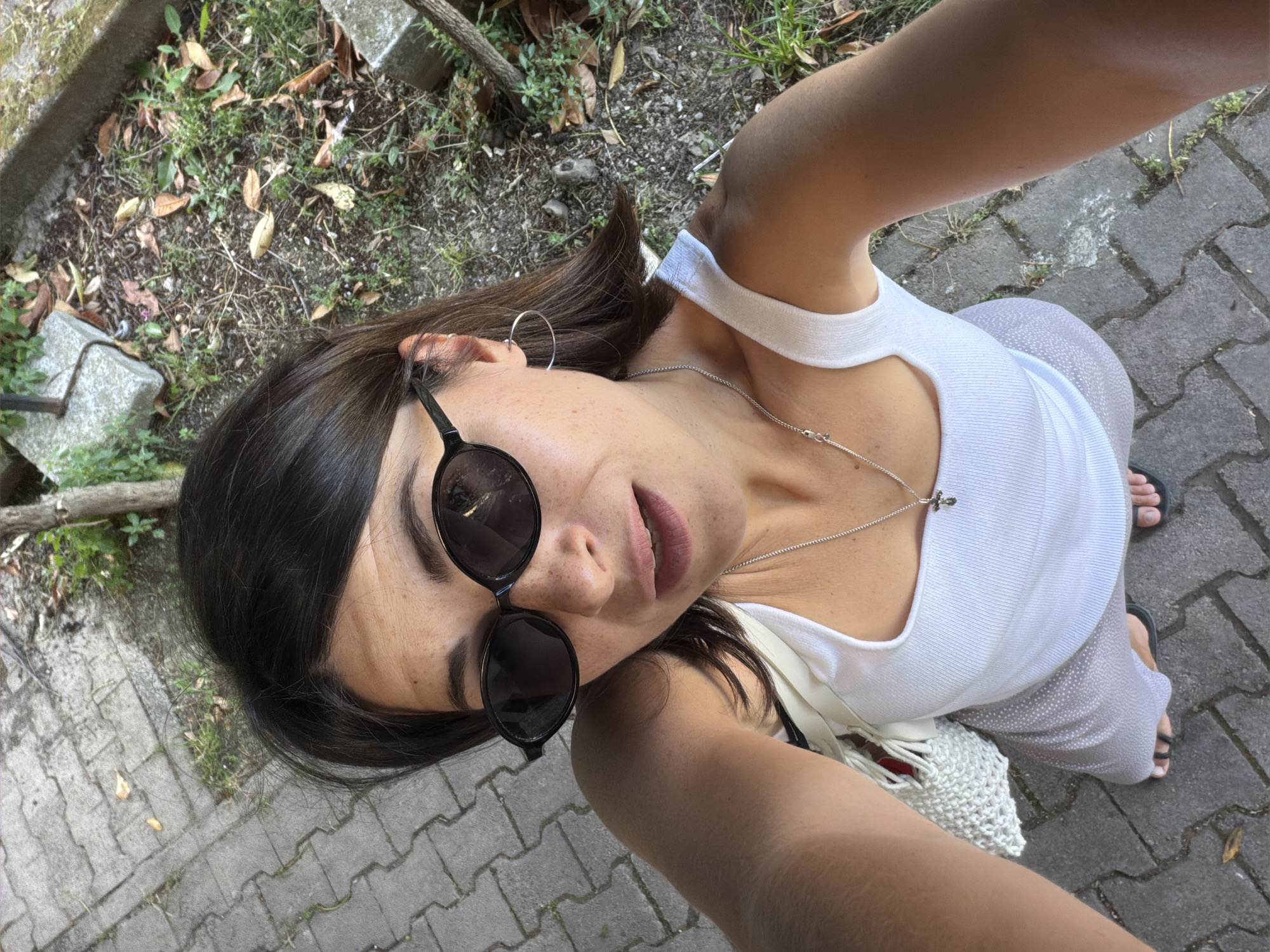 Woman poses for selfies among pink hydrangeas in Budva