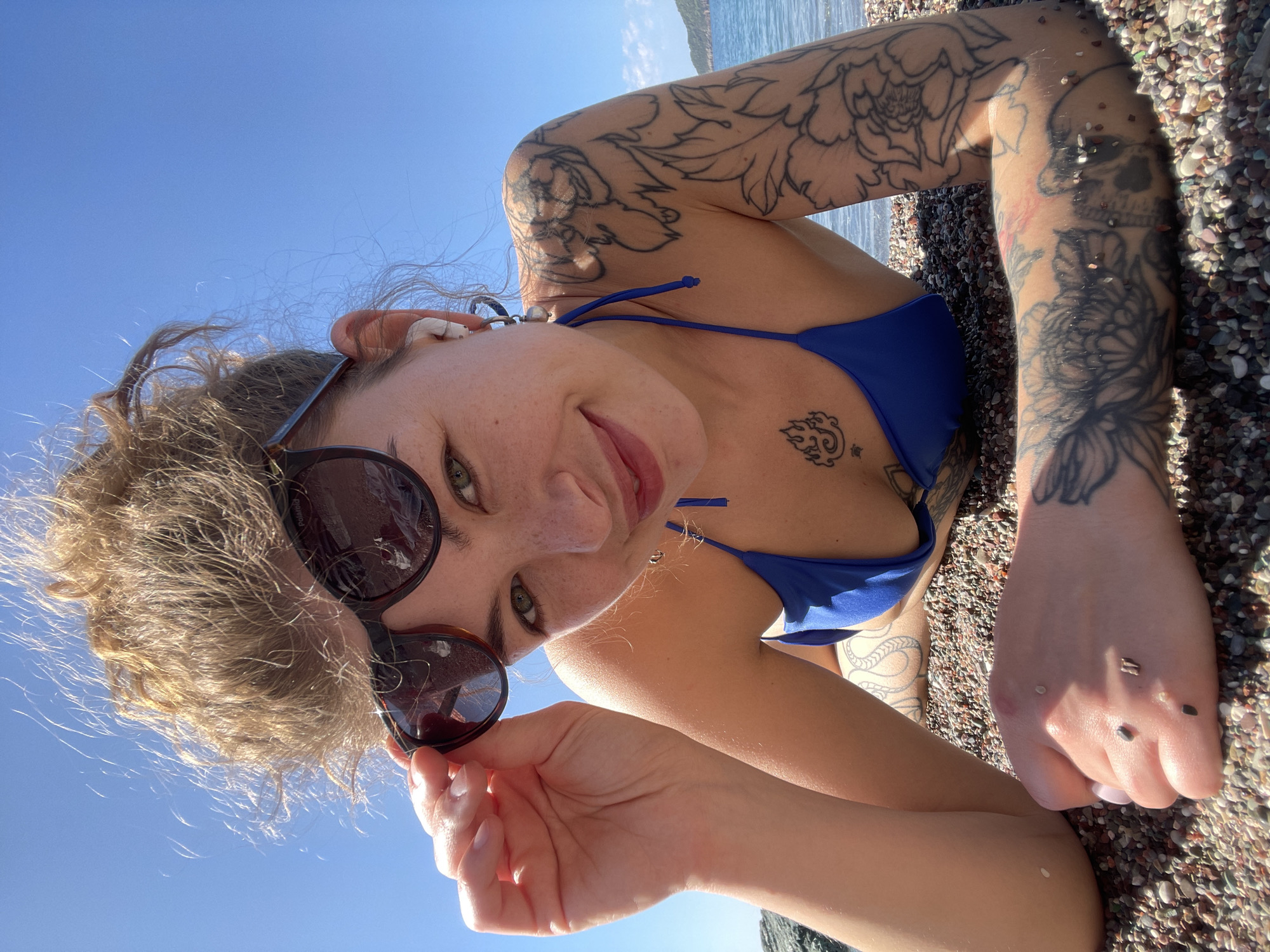 Woman photographed on sunny Montenegro beach in blue bikini