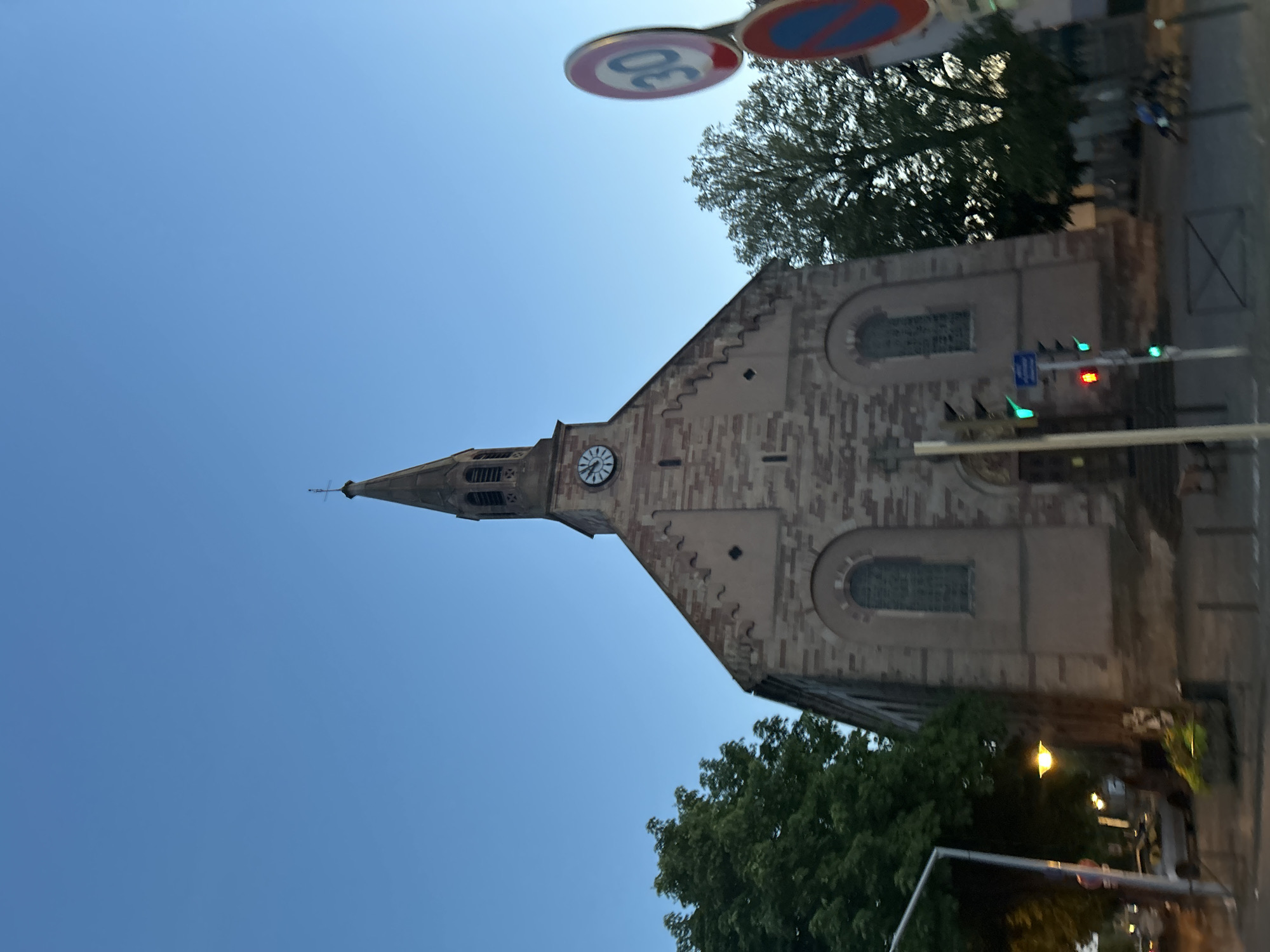 Stone church with clock steeple on a clear day in Strasbourg