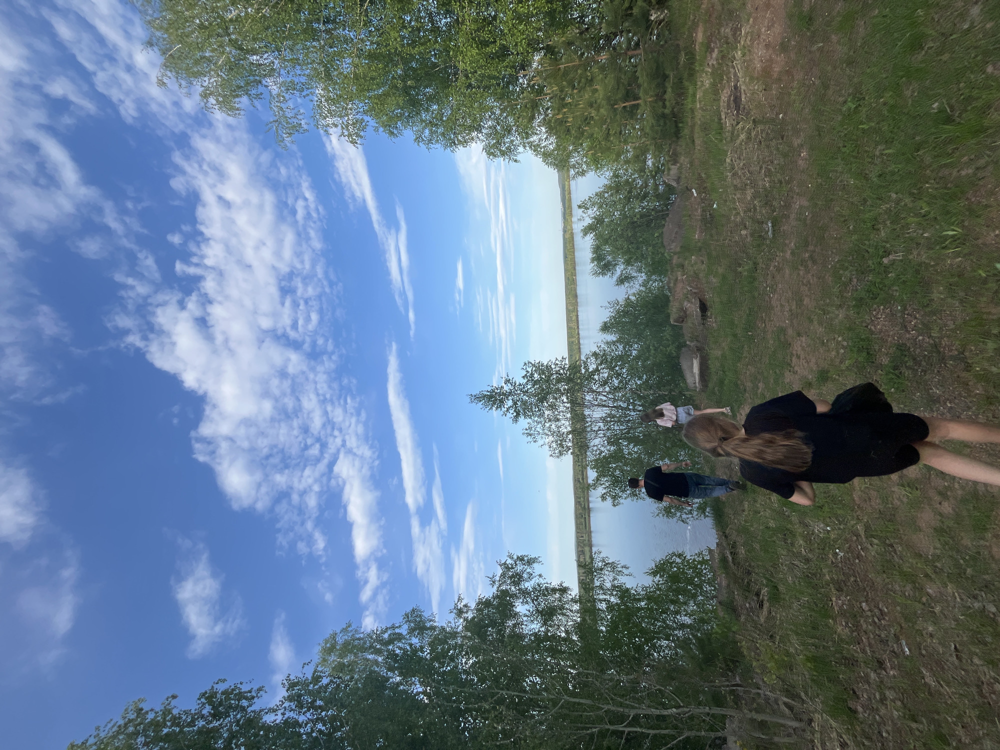 Woman takes selfies at canal waterway in Chernushka, Russia