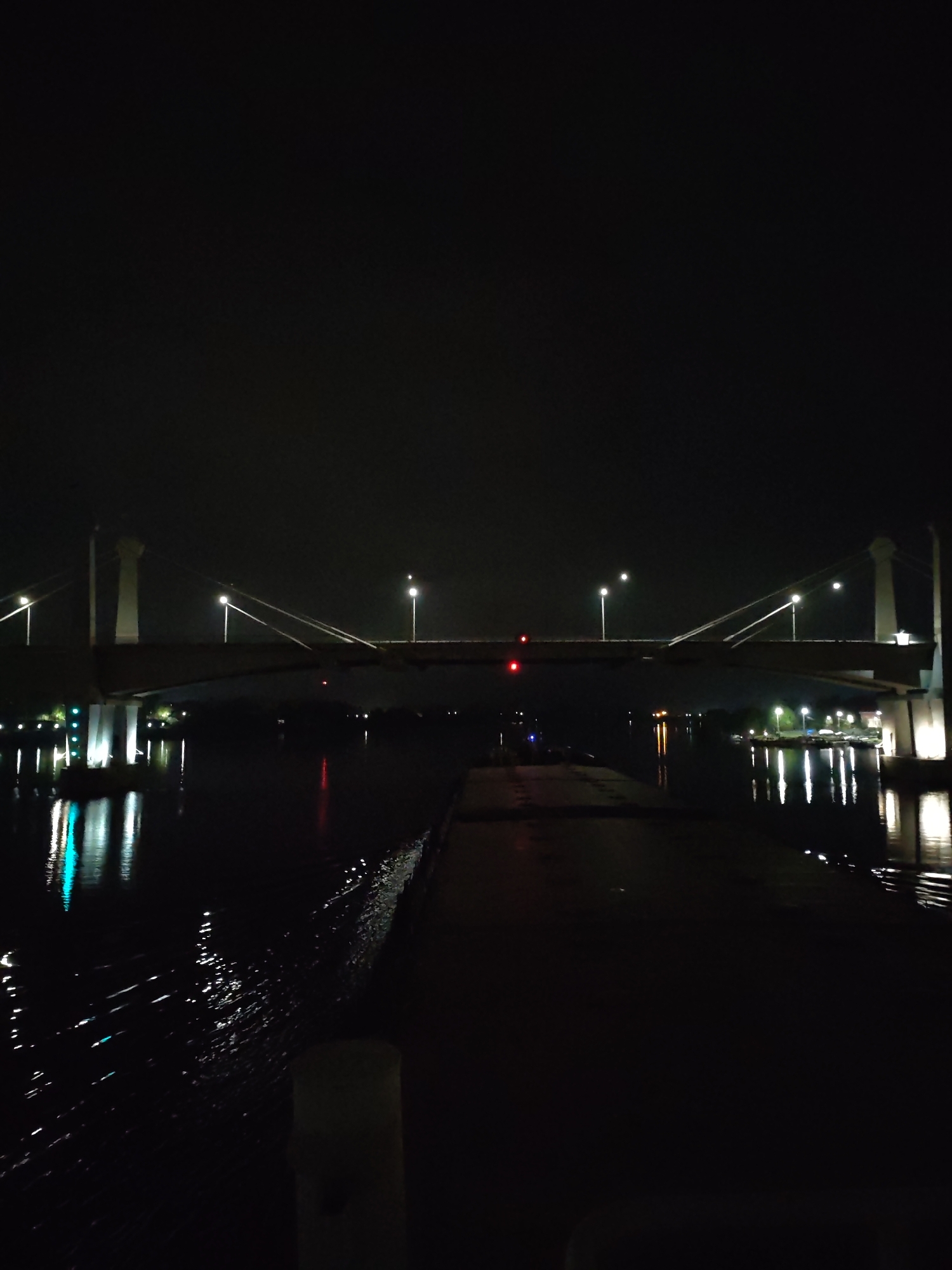 Illuminated Kimry Bridge captured in nighttime riverside documentation