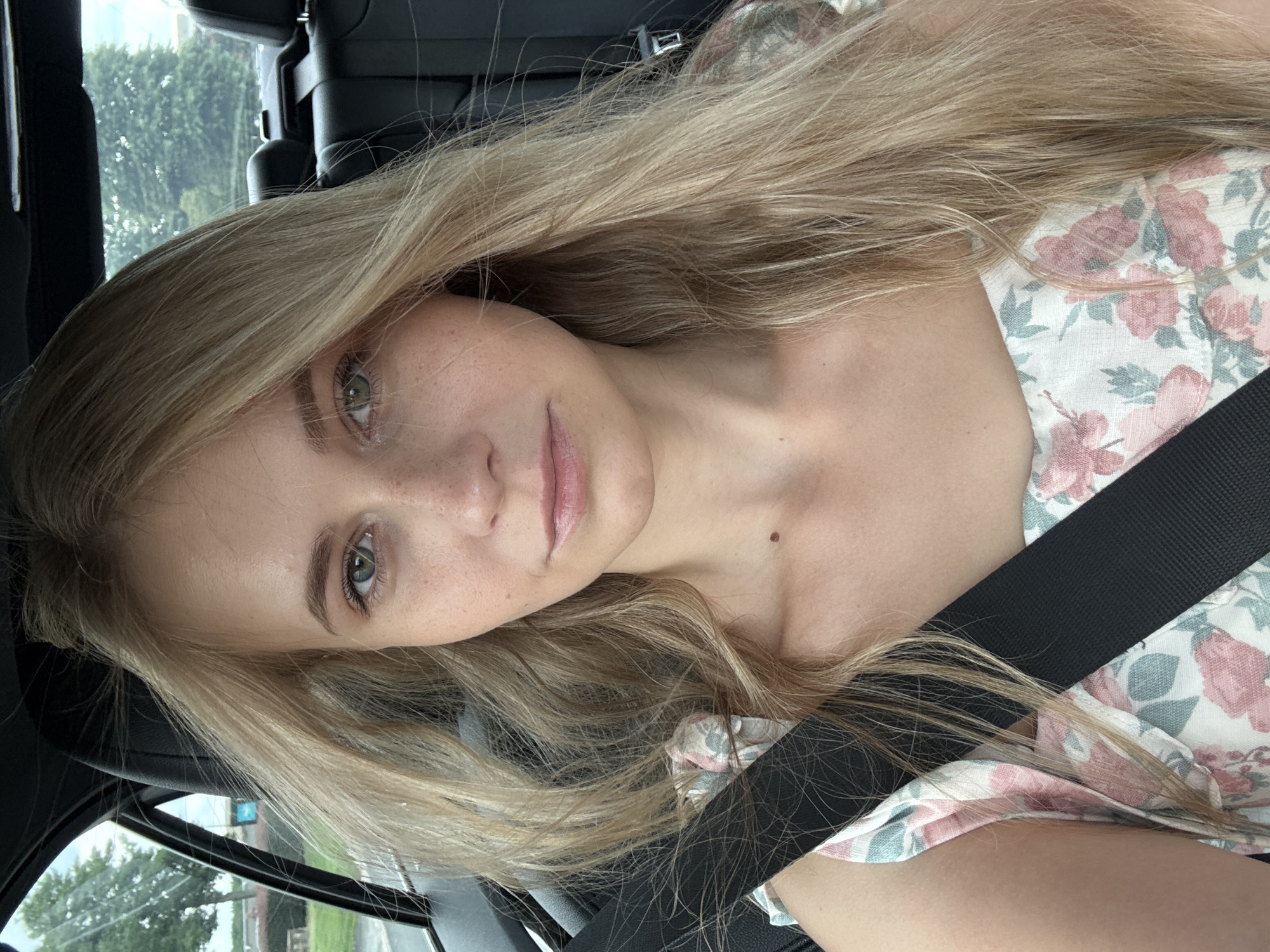 Passenger seat ride through Greenville, floral dress, mid-motion