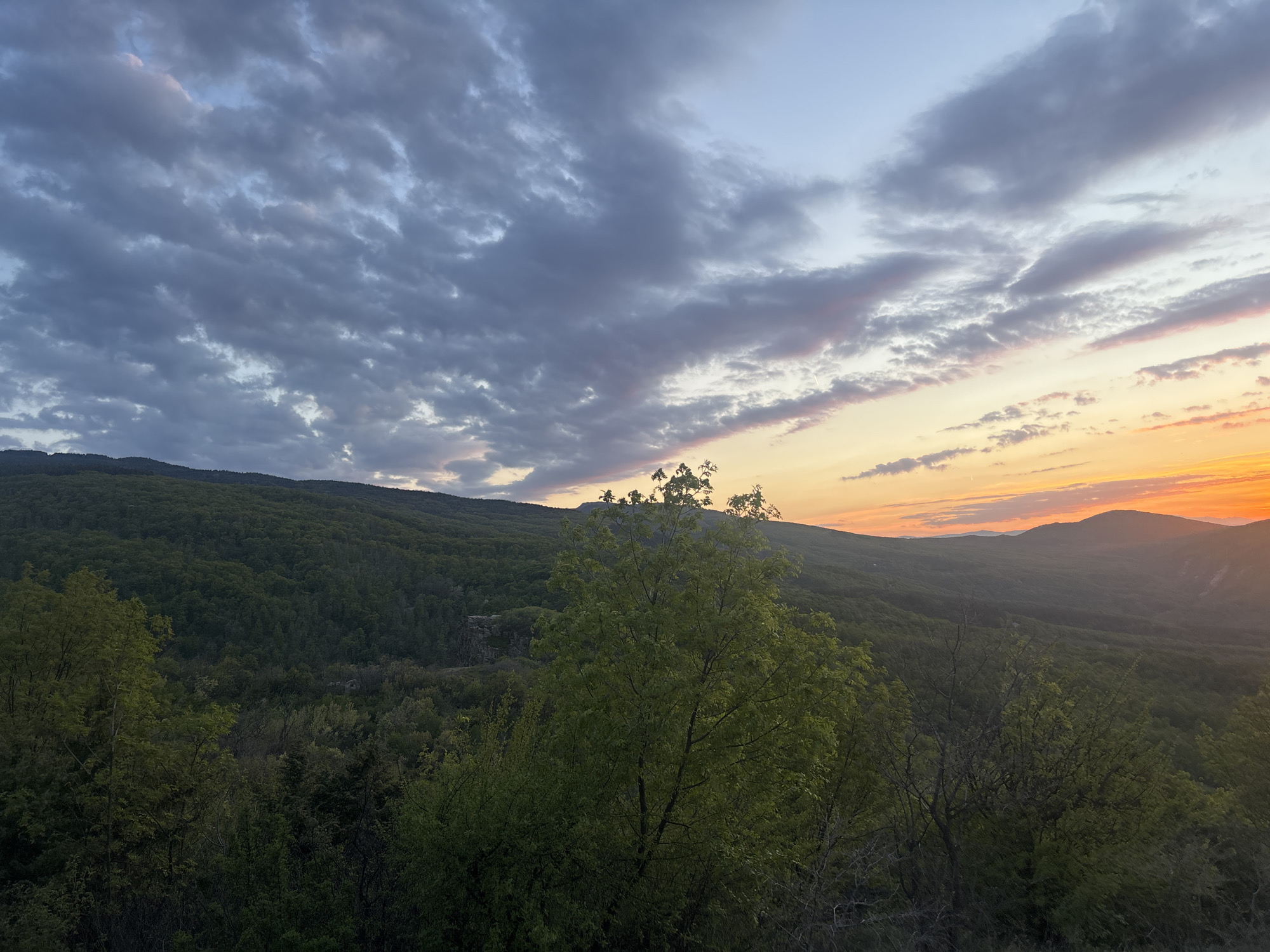 Sunset documented over forested hills near Izvor, Bulgaria