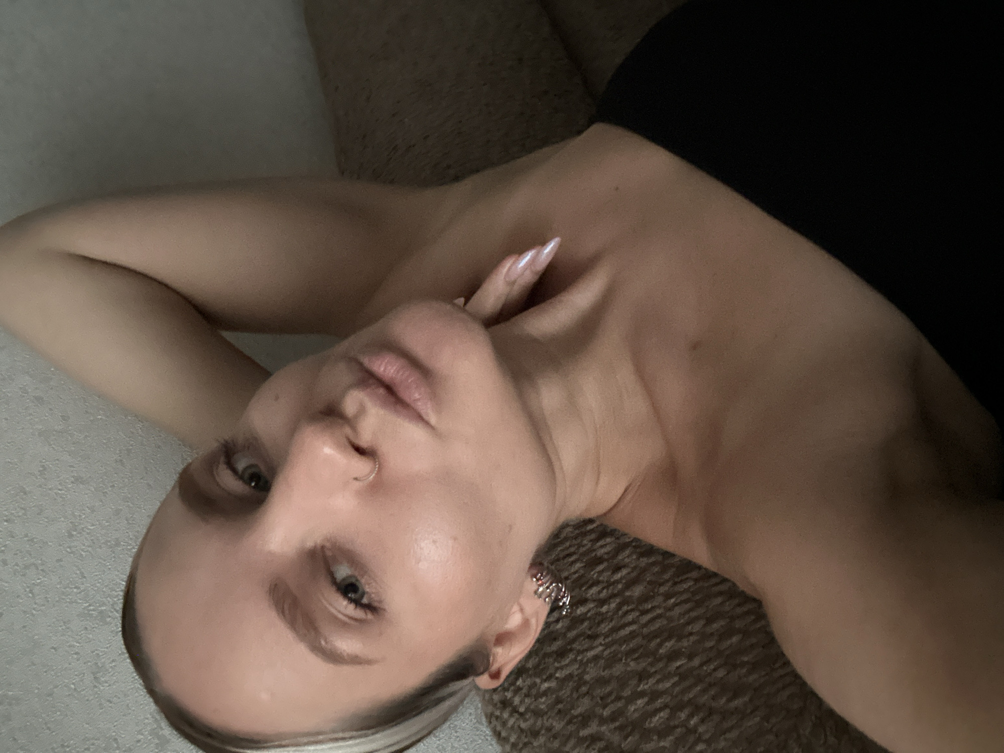 Woman poses casually on couch in Esenyurt apartment
