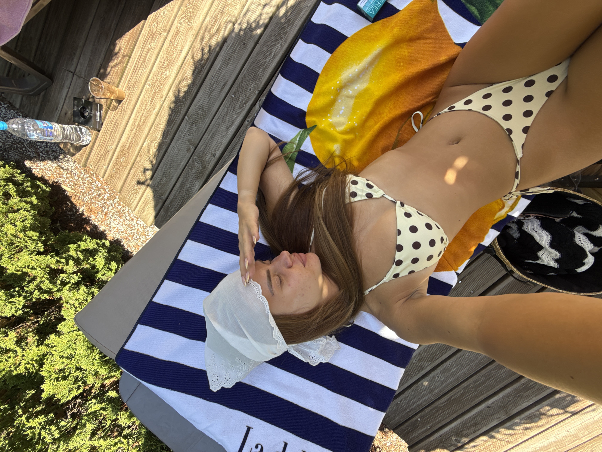 Sunbathing on a striped towel in Plovdiv, midsummer