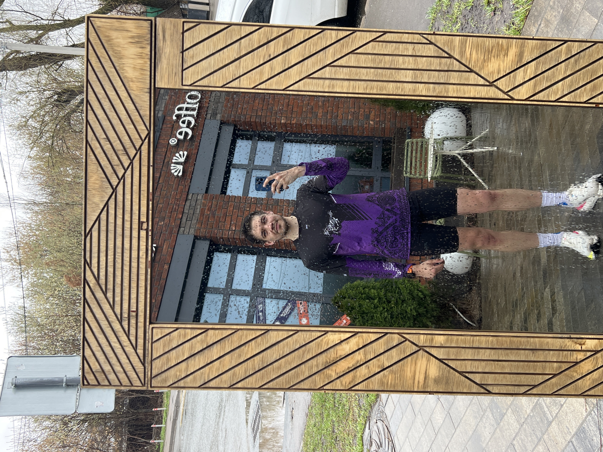 Man takes rainy morning selfie outside Kazan coffee shop
