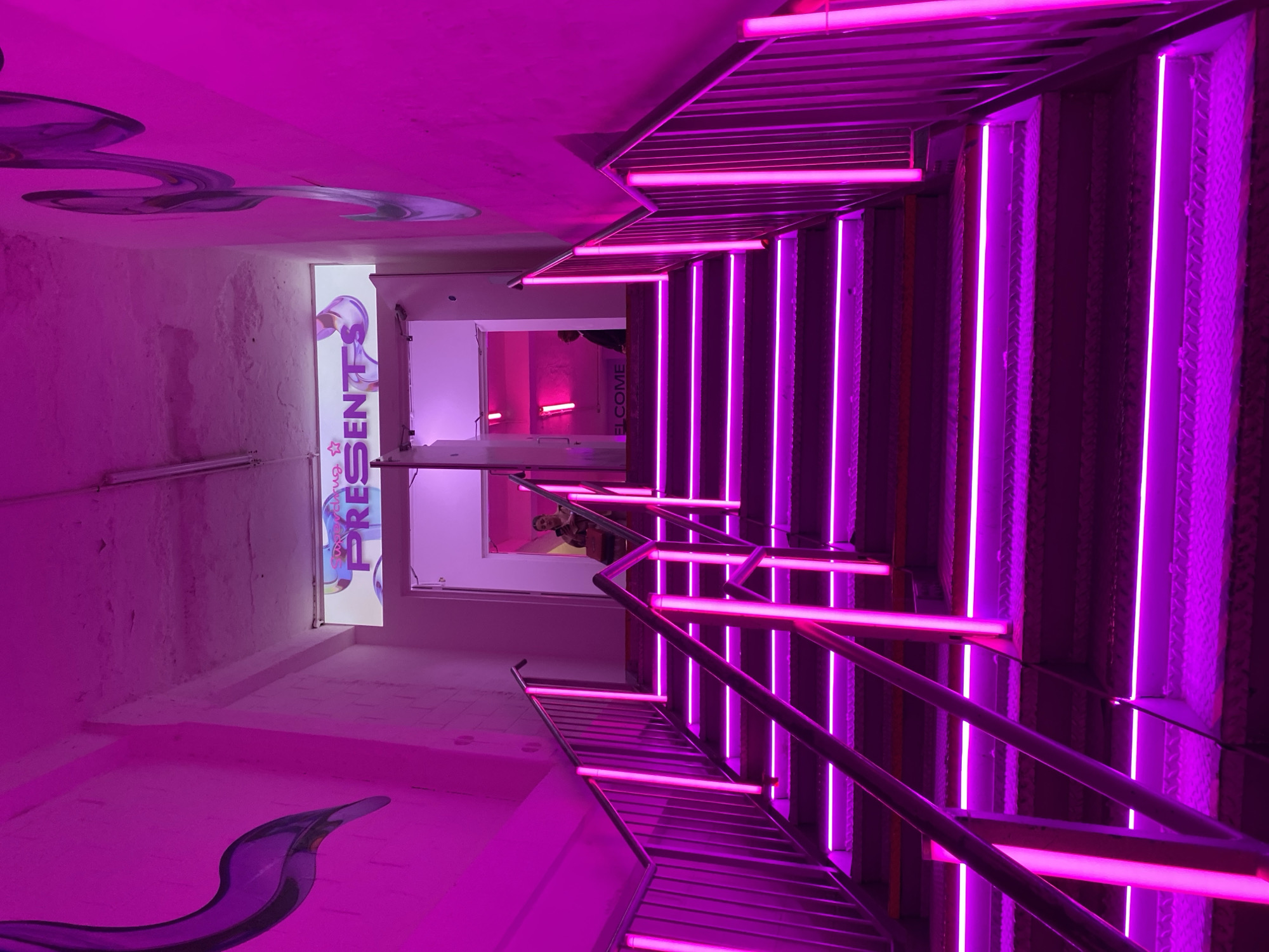 Person photographed in pink-lit London venue