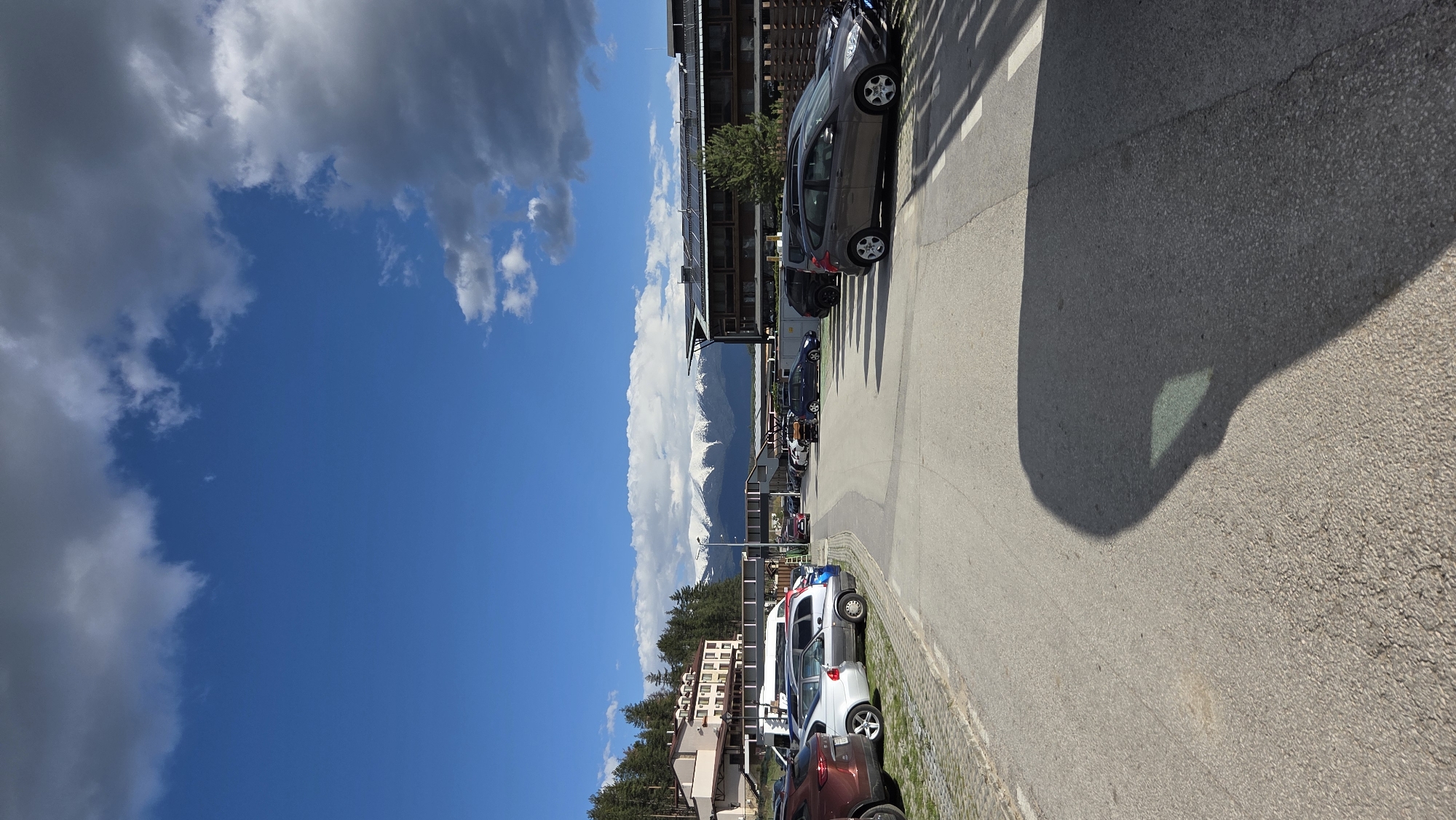 Cars parked along urban roadway observed early morning