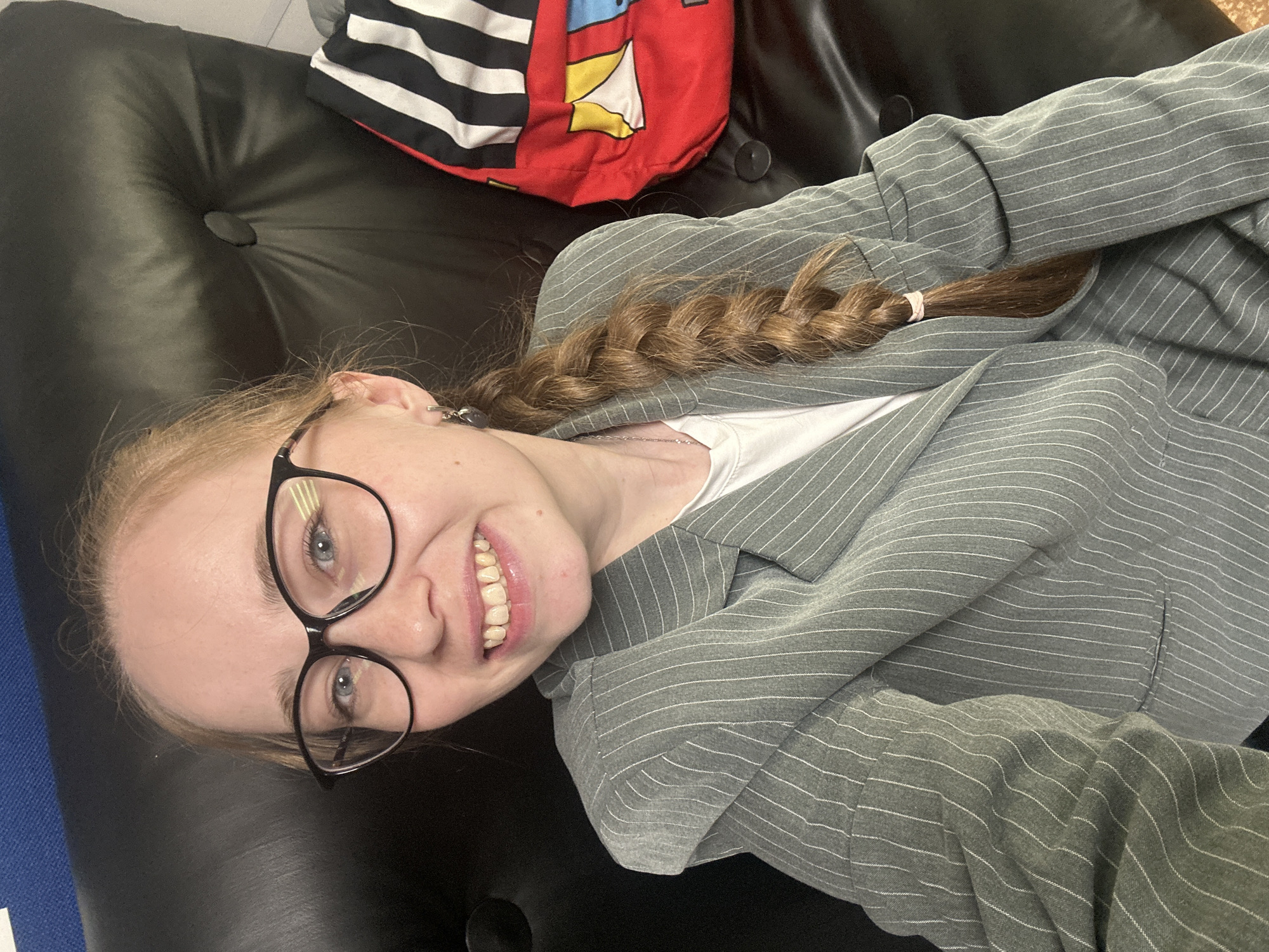 Woman in blazer photographed smiling in Saint Petersburg