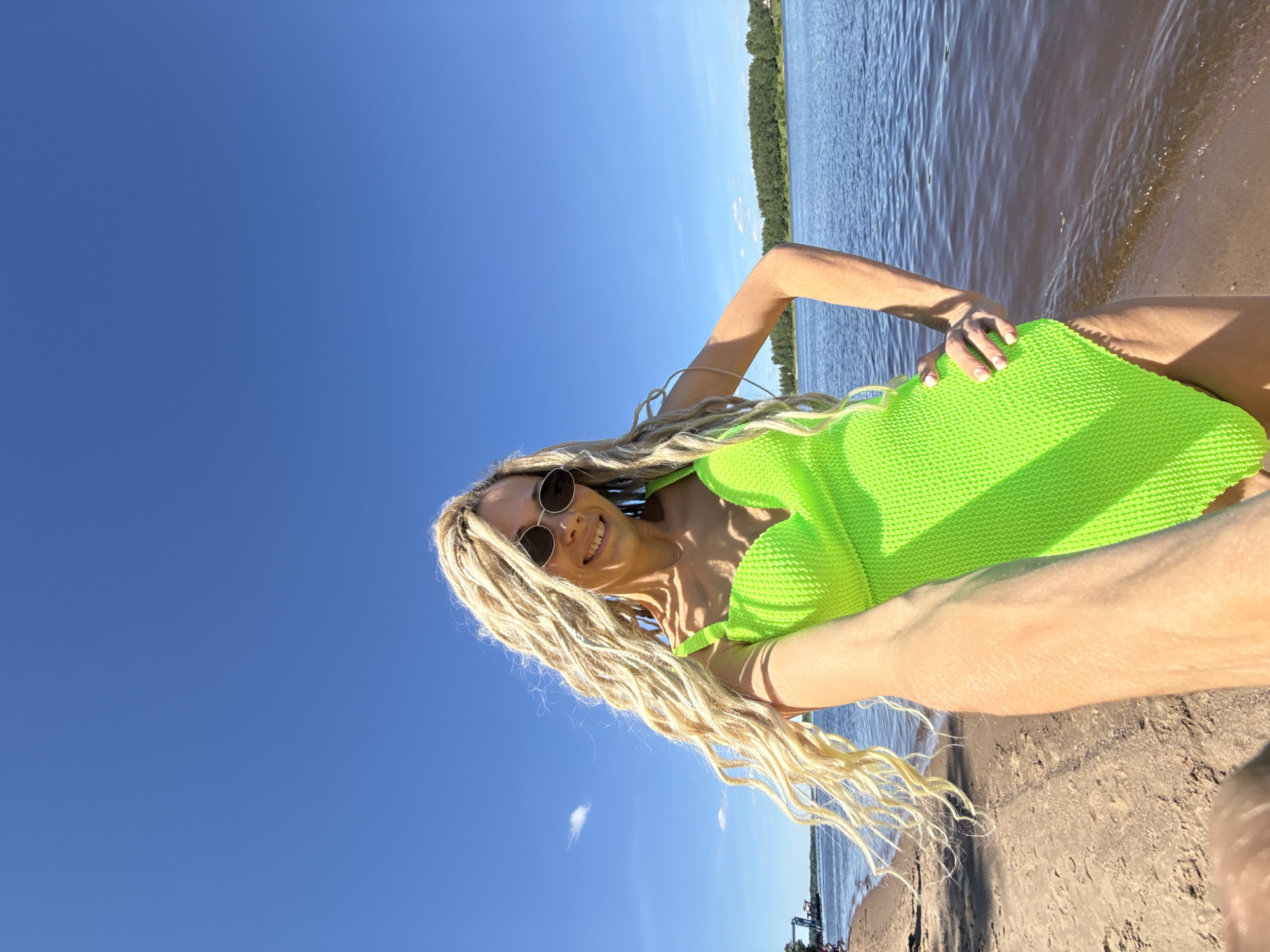 Woman takes selfie in neon green outfit
