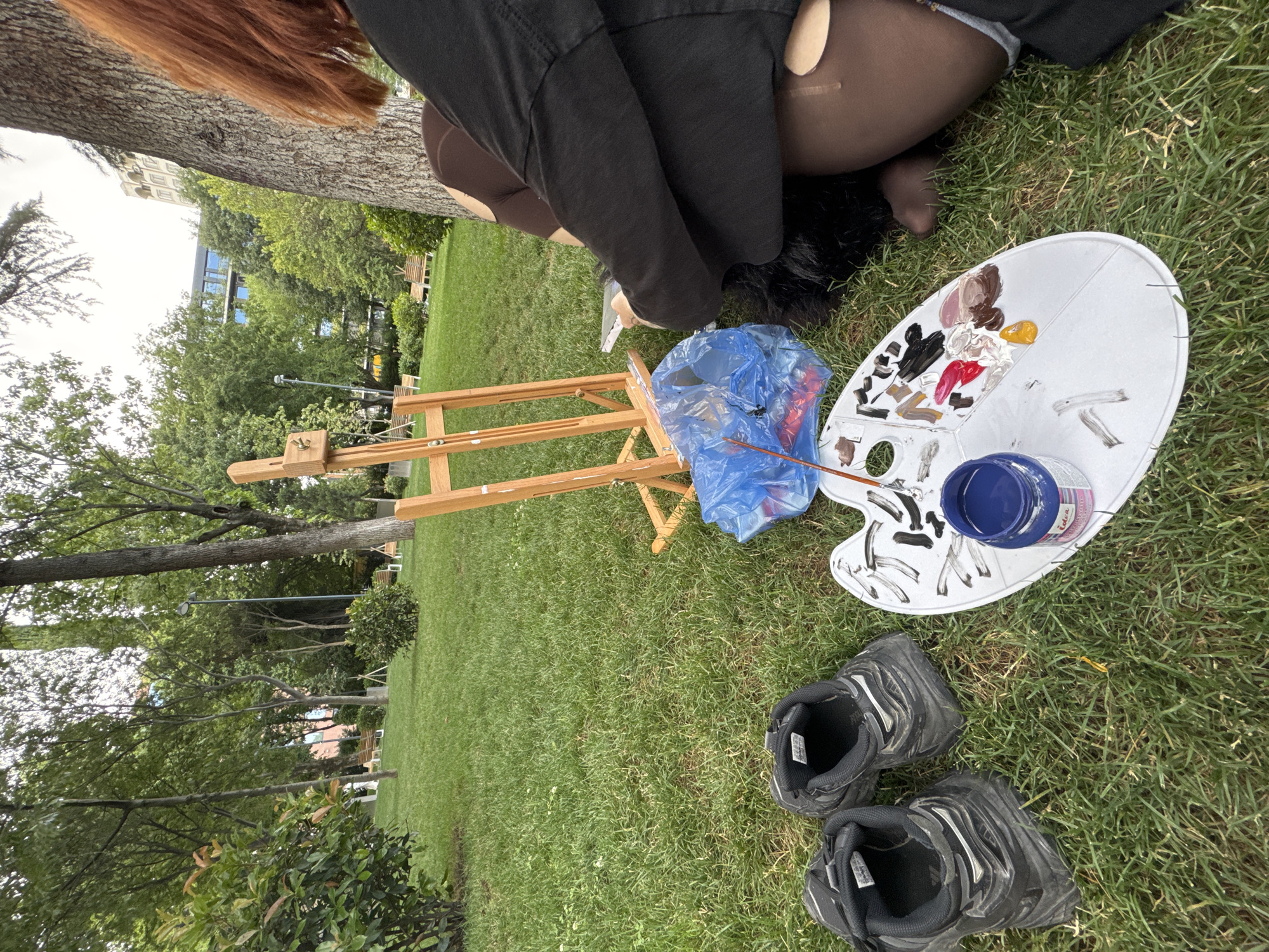 Red-haired artist paints anime portrait in Tbilisi park
