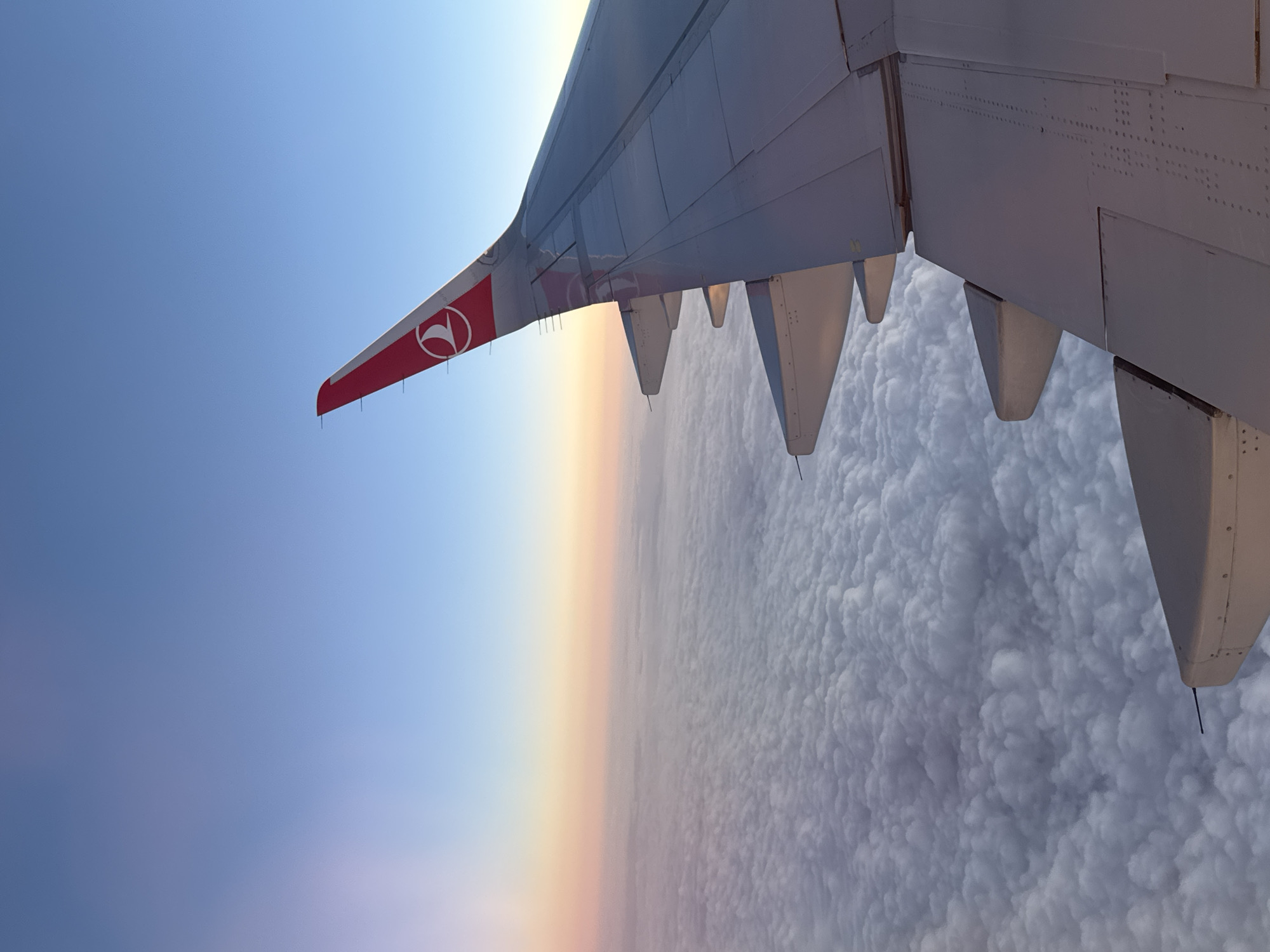 Turkish Airlines flight captured in aerial view at sunset
