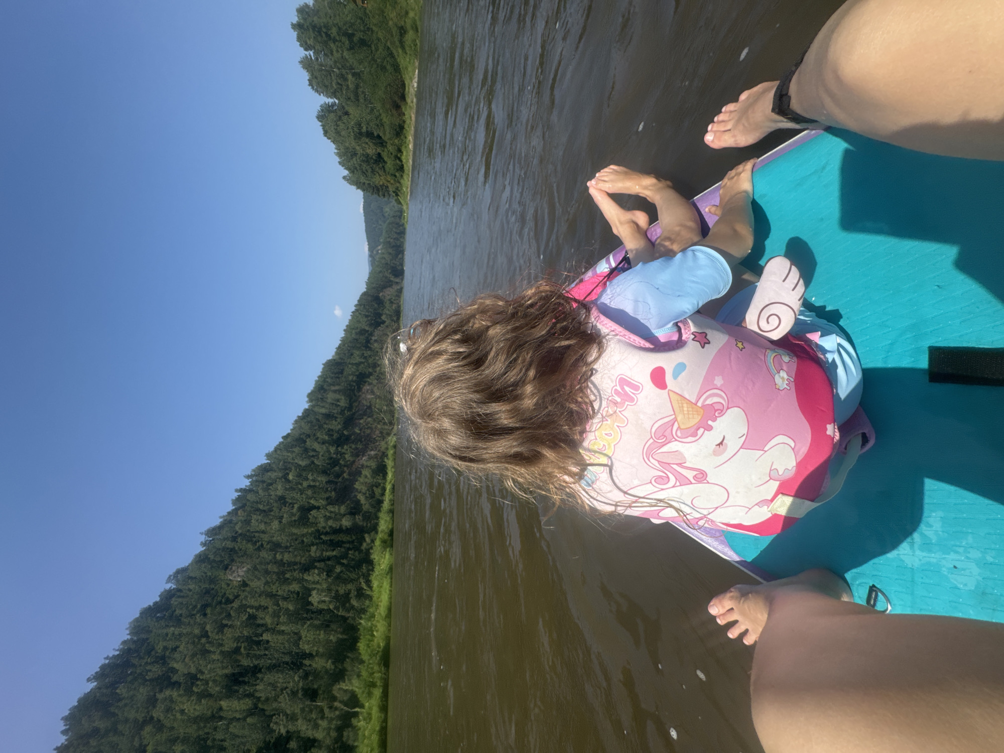 Paddleboarding the calm, tree-lined Mana River in Siberia