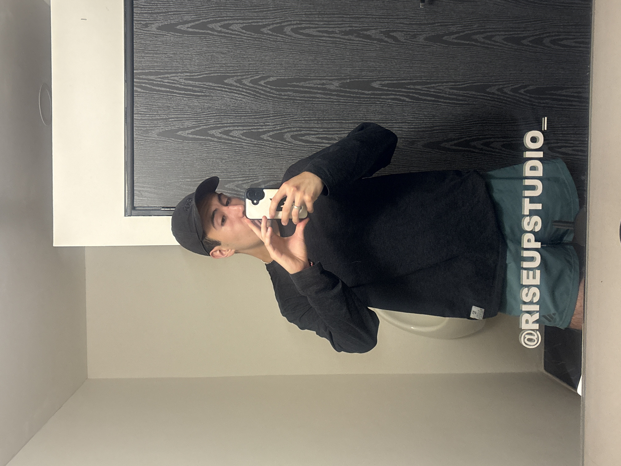 Young man takes mirror selfies in Mexican bathroom