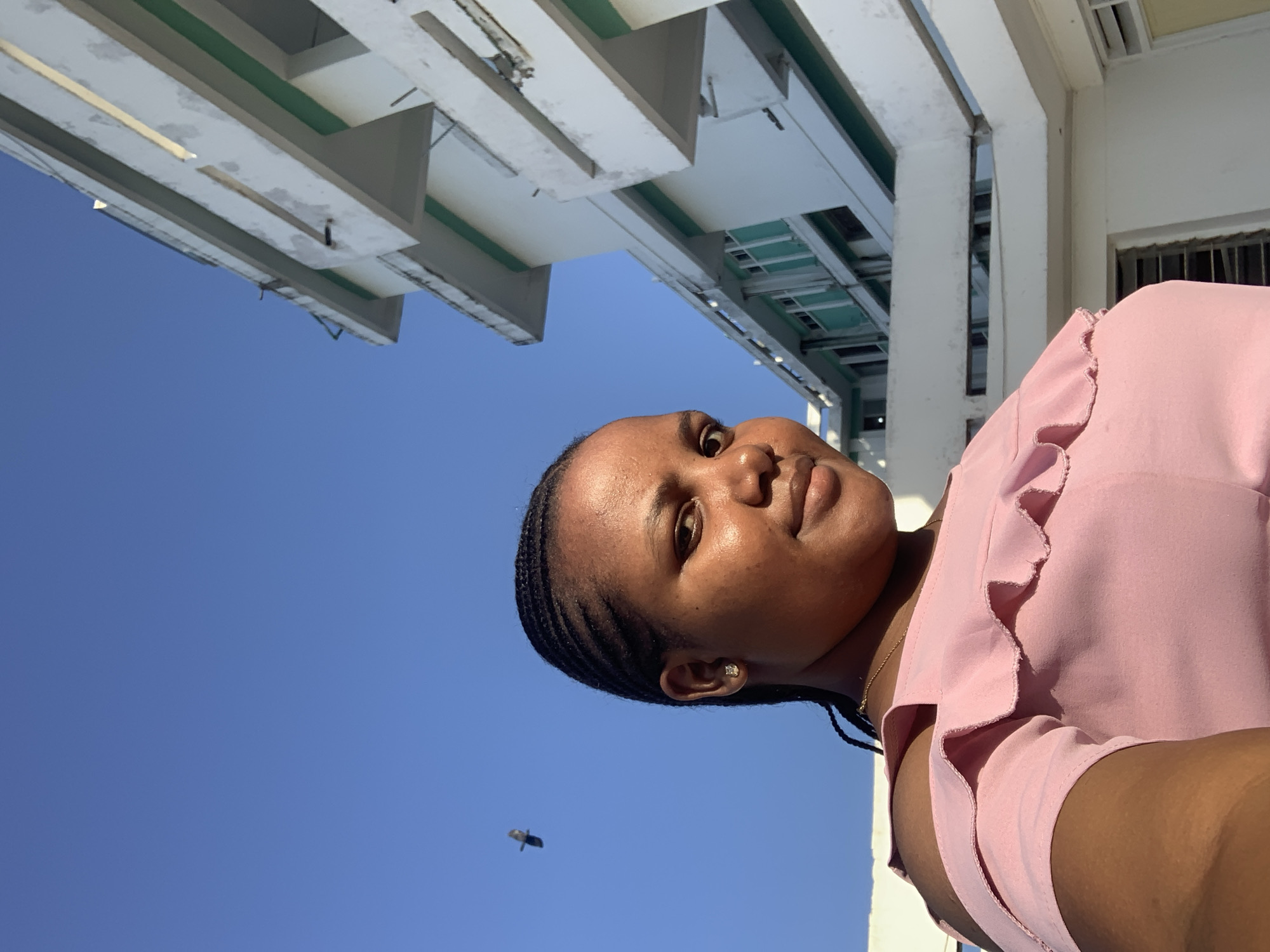 Woman photographed smiling under clear sky in Dar es Salaam