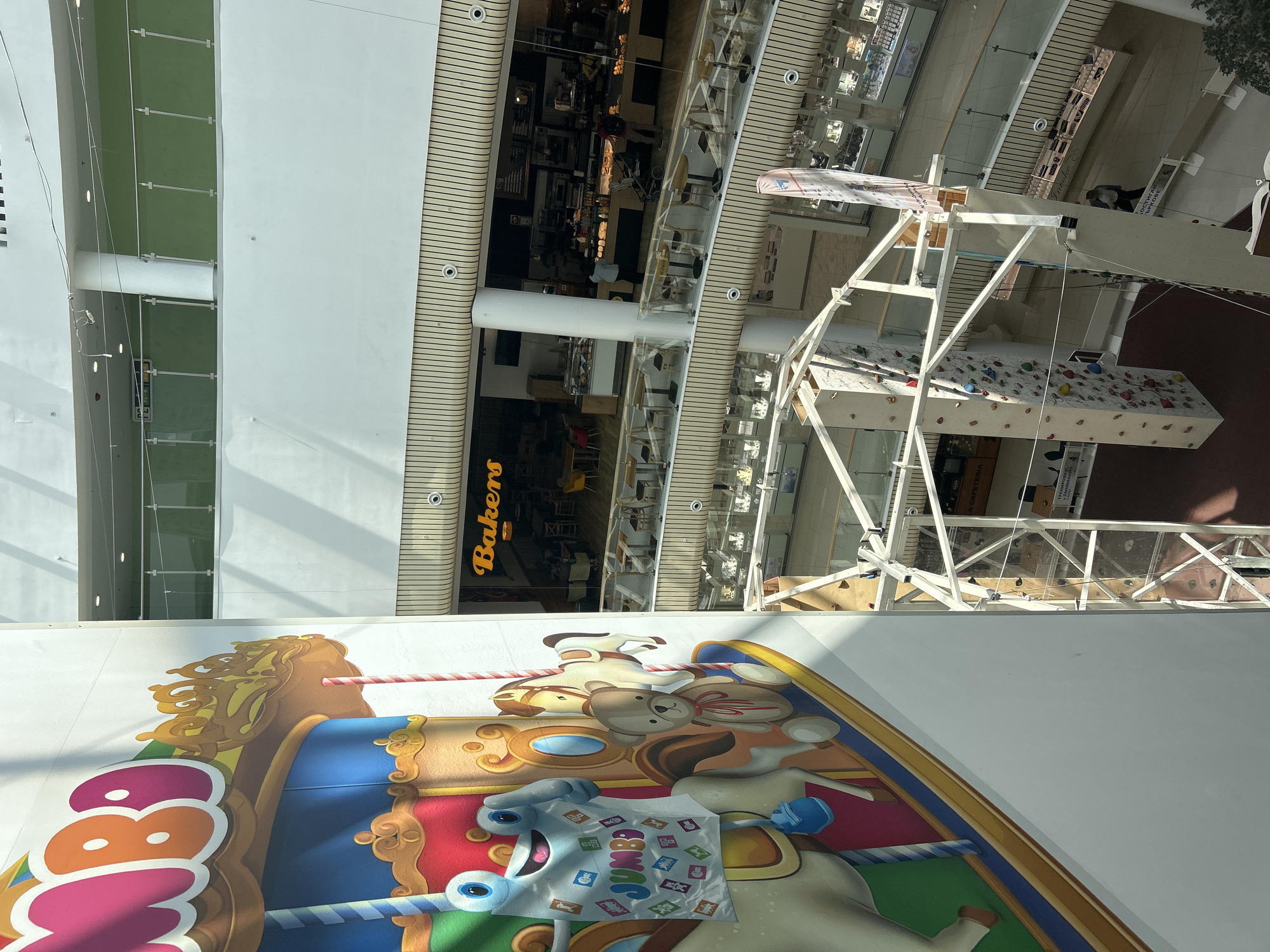 Shopping mall interior with carousel mural observed in Plovdiv