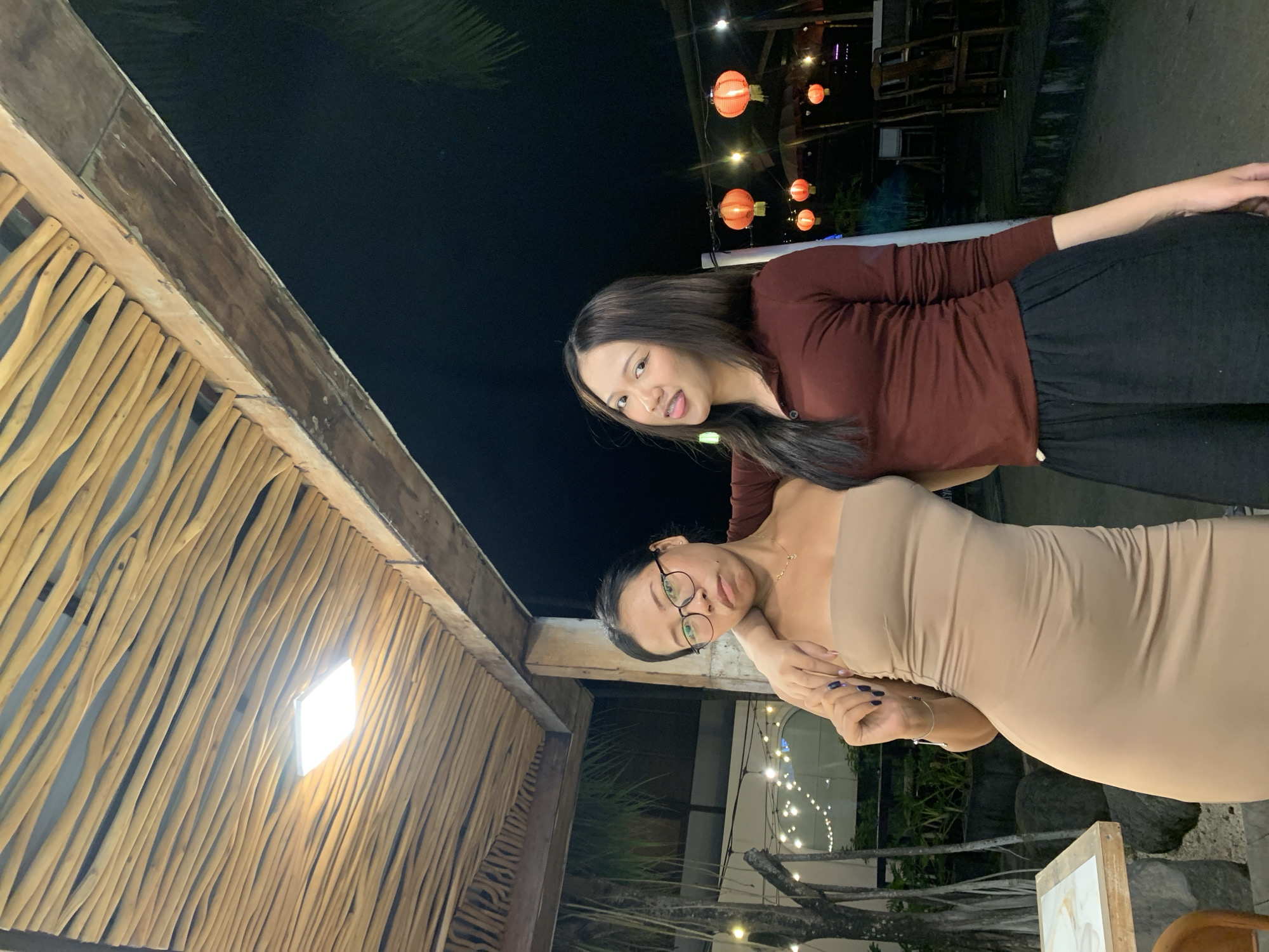 Two women photograph together at North Kuta restaurant venue