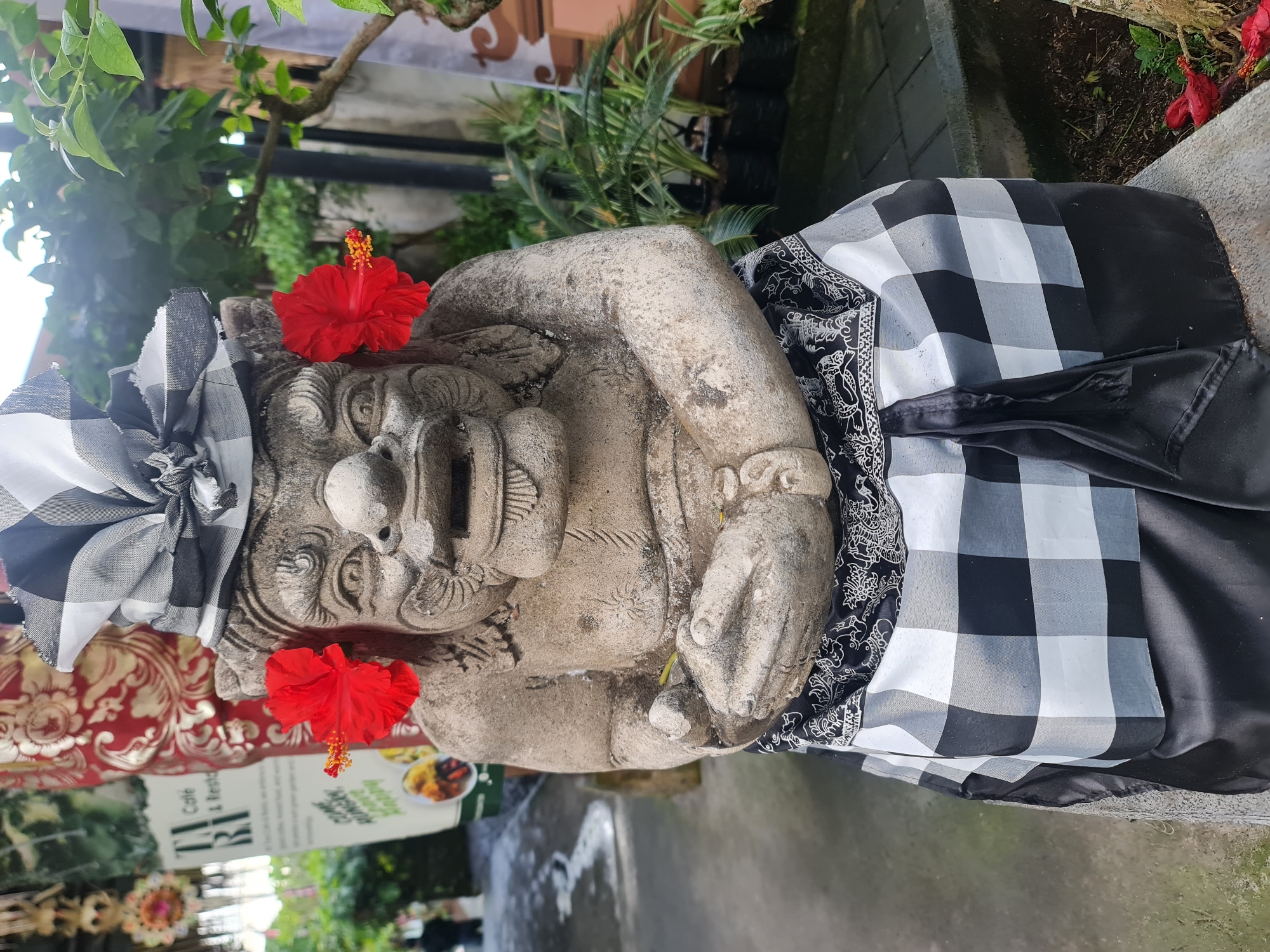 Balinese demon statues with ceremonial decorations in Gianyar