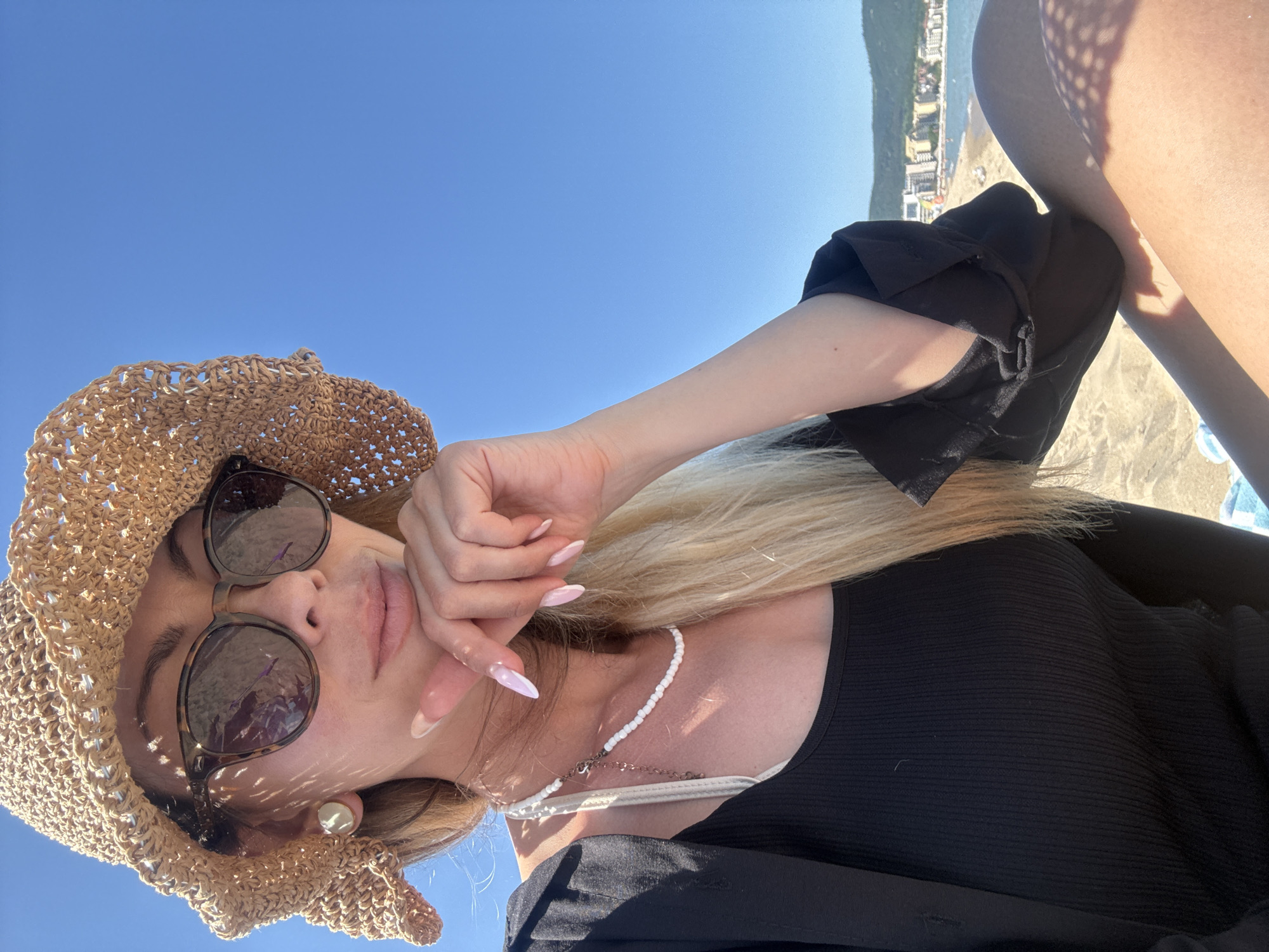 Woman enjoys sunny beach day in Nesebar, Bulgaria