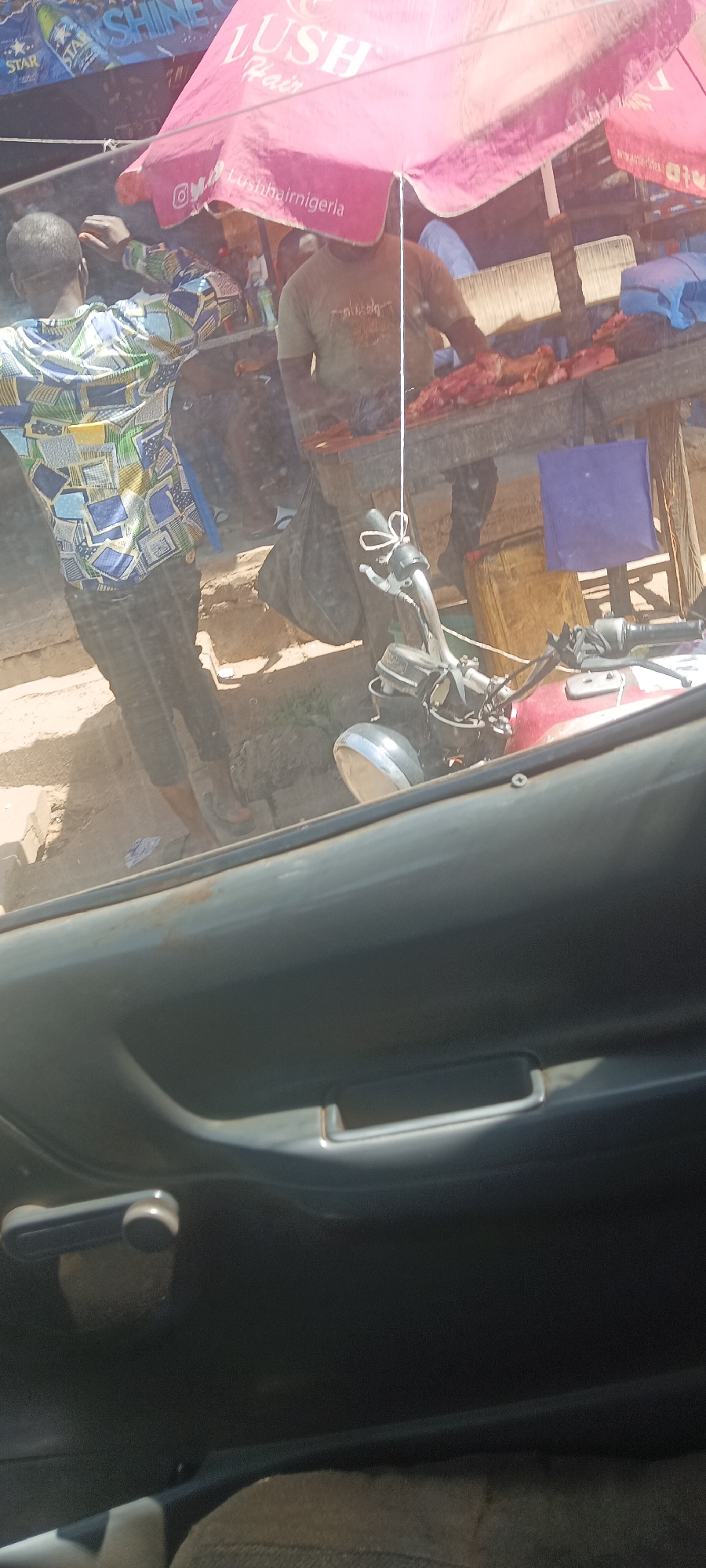 Street meat market spotted under branded umbrella in Nigeria