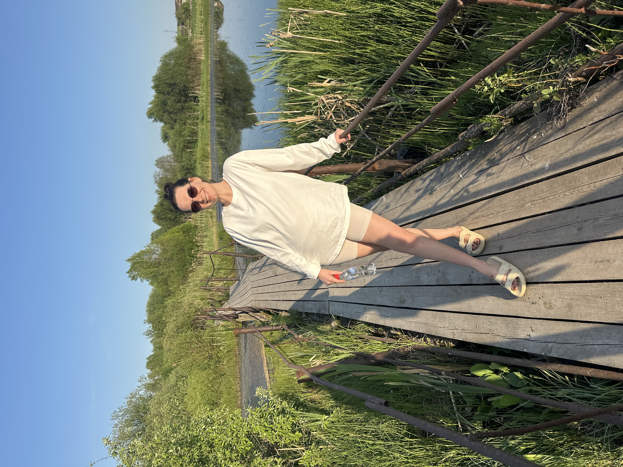 Woman photographed at lakeside boardwalk in Альняш, Russia