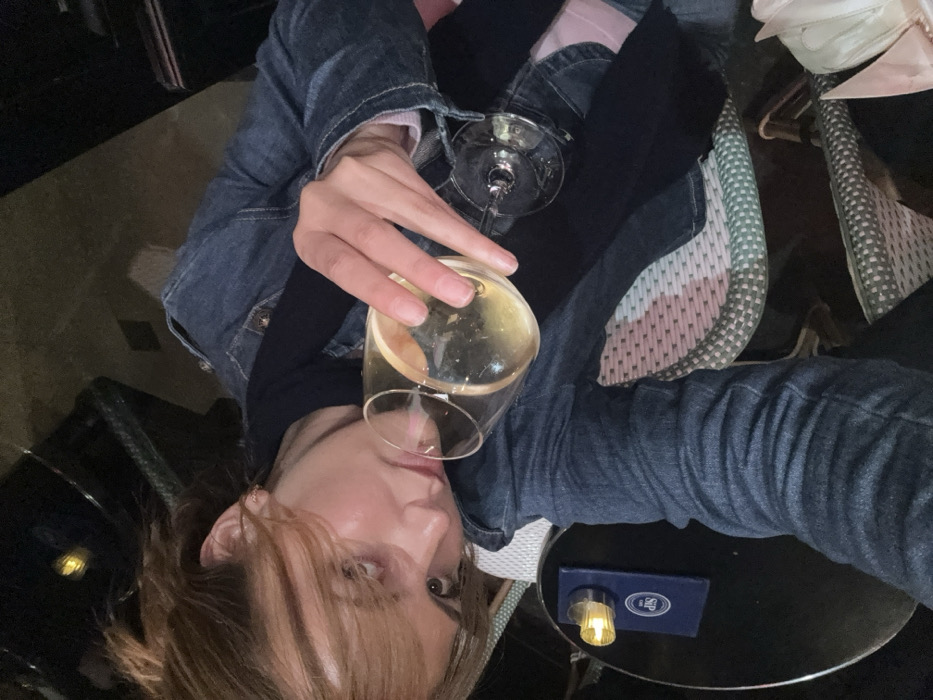 Two women share wine and conversation at Paris cafe