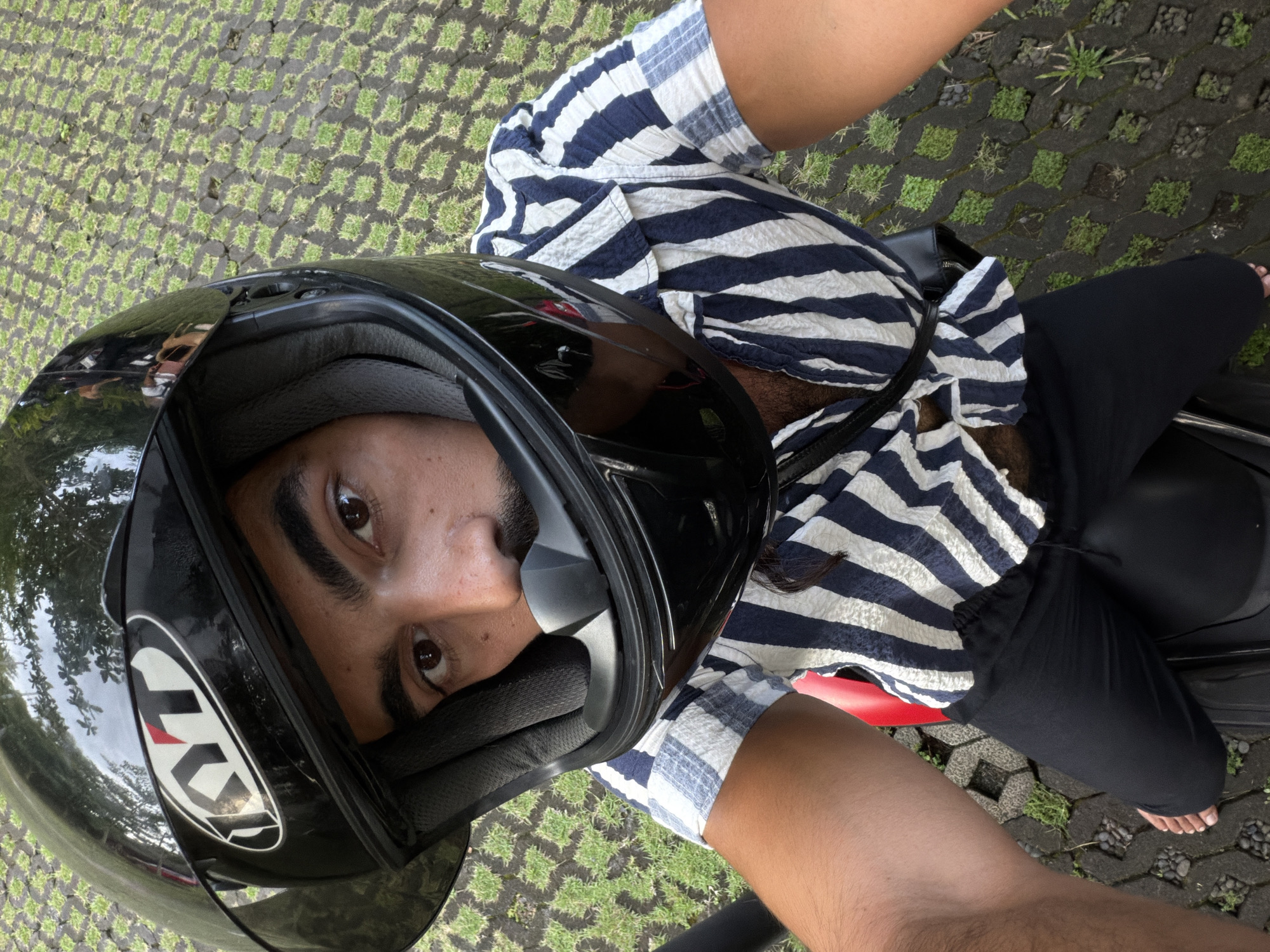 Motorcyclist Takes Selfie on Red Bike in Sukawati